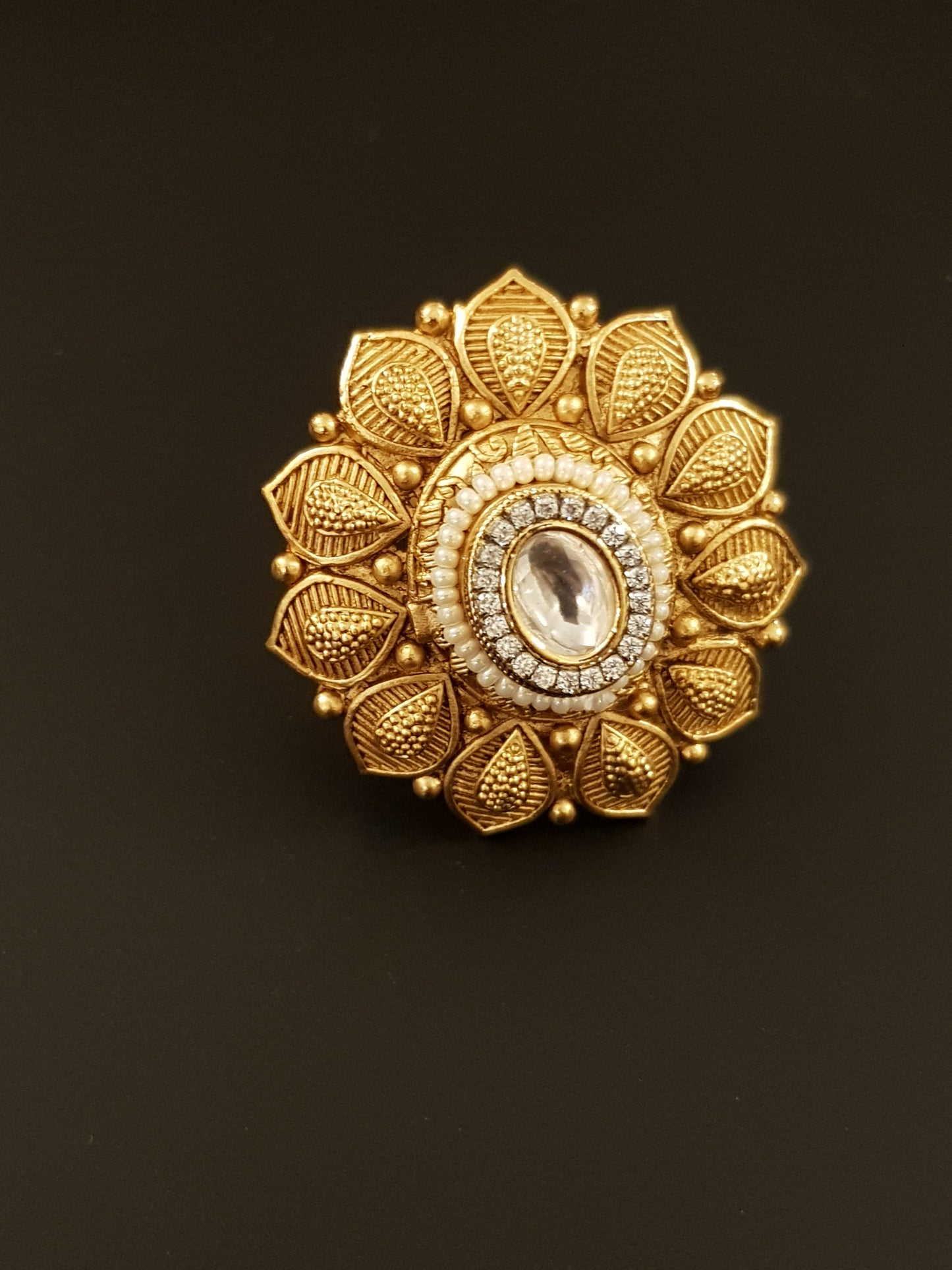 Gold finish flower motif ring with kundan stone and pearl detailing