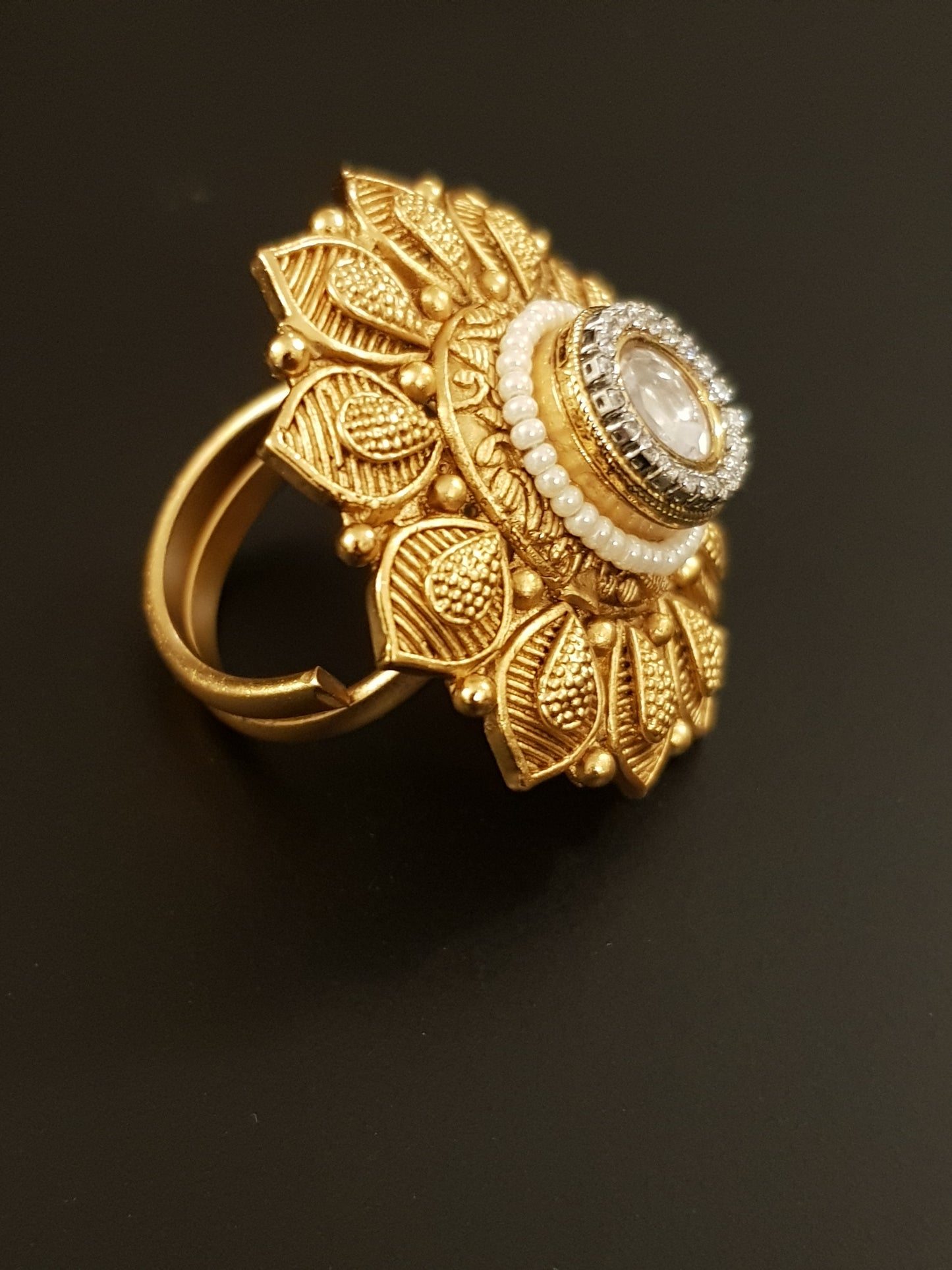 Gold finish flower motif ring with kundan stone and pearl detailing