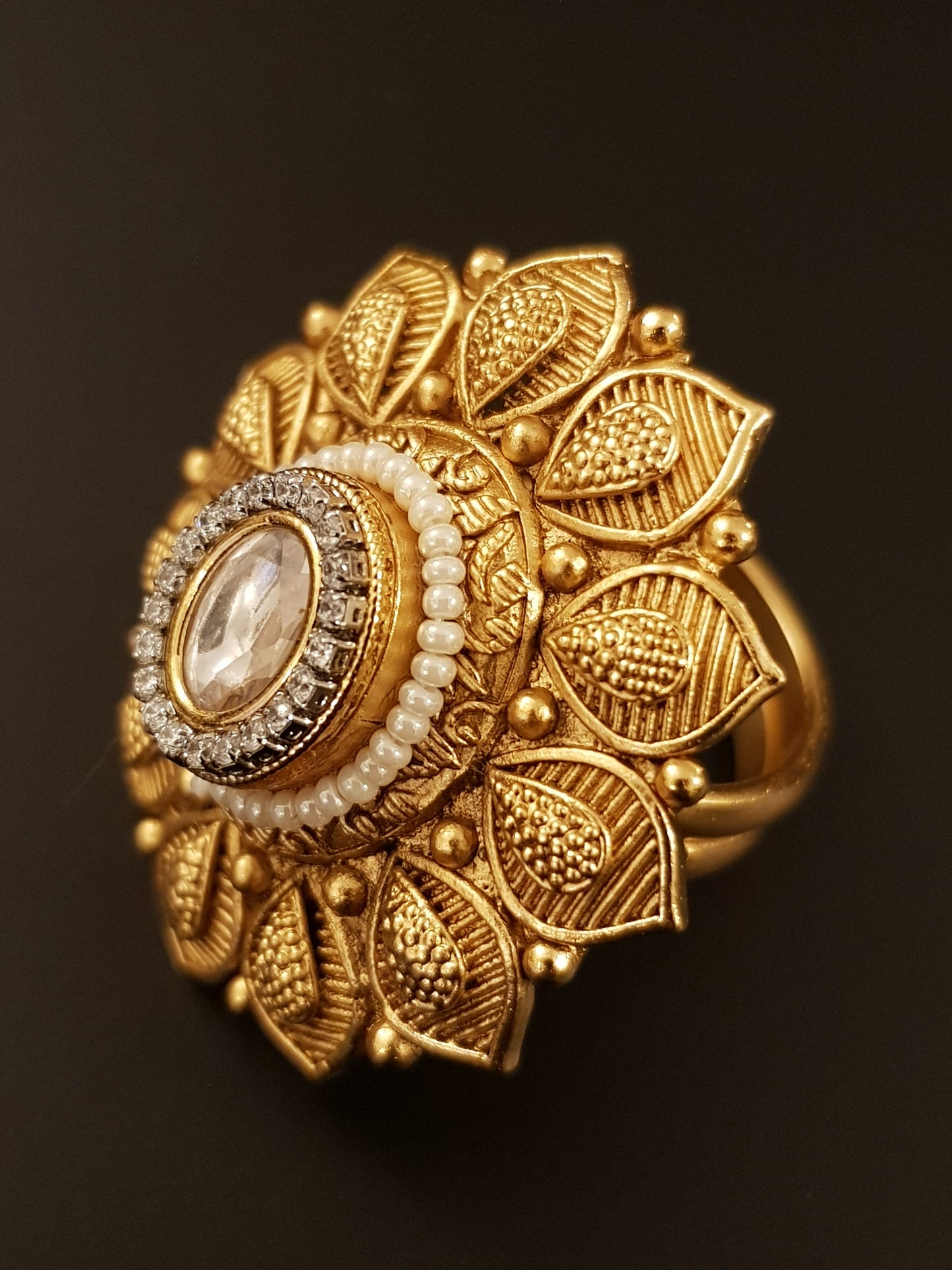 Gold finish flower motif ring with kundan stone and pearl detailing