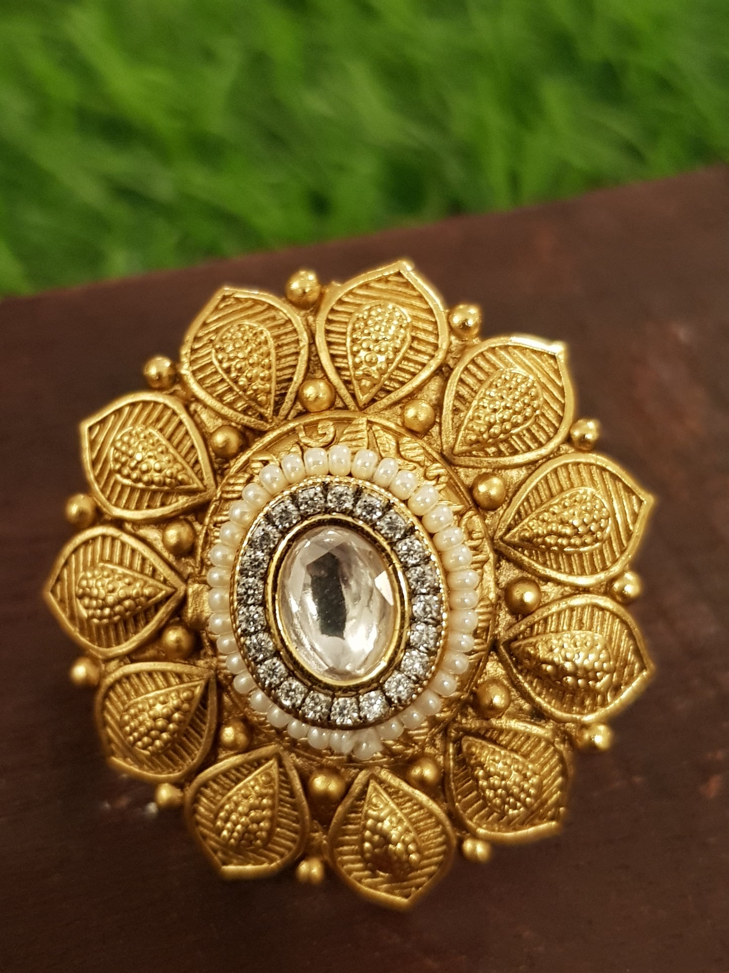 Gold finish flower motif ring with kundan stone and pearl detailing