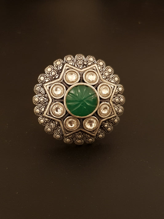 Silver finish ring with emerald stone and kundan detailing