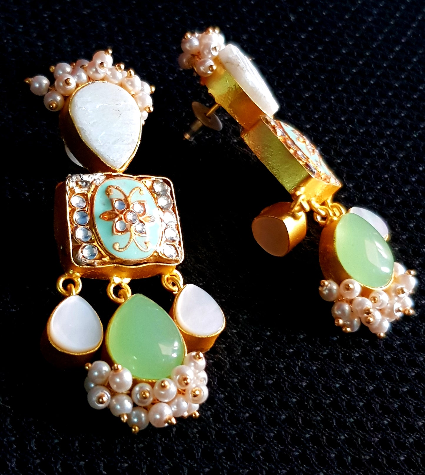 Gold finish earrings with meenakari,mother of pearl and pale green stone drops