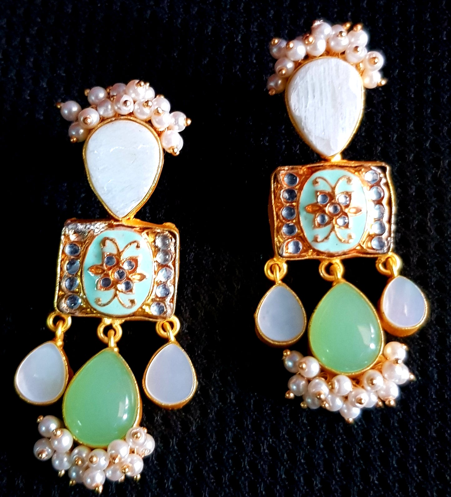 Gold finish earrings with meenakari,mother of pearl and pale green stone drops