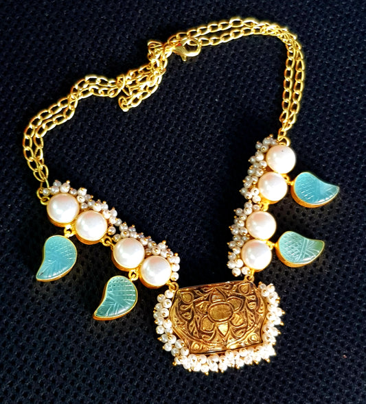 Neacklace in gold finish with black meenakari pendant and paisley design aqua blue stone