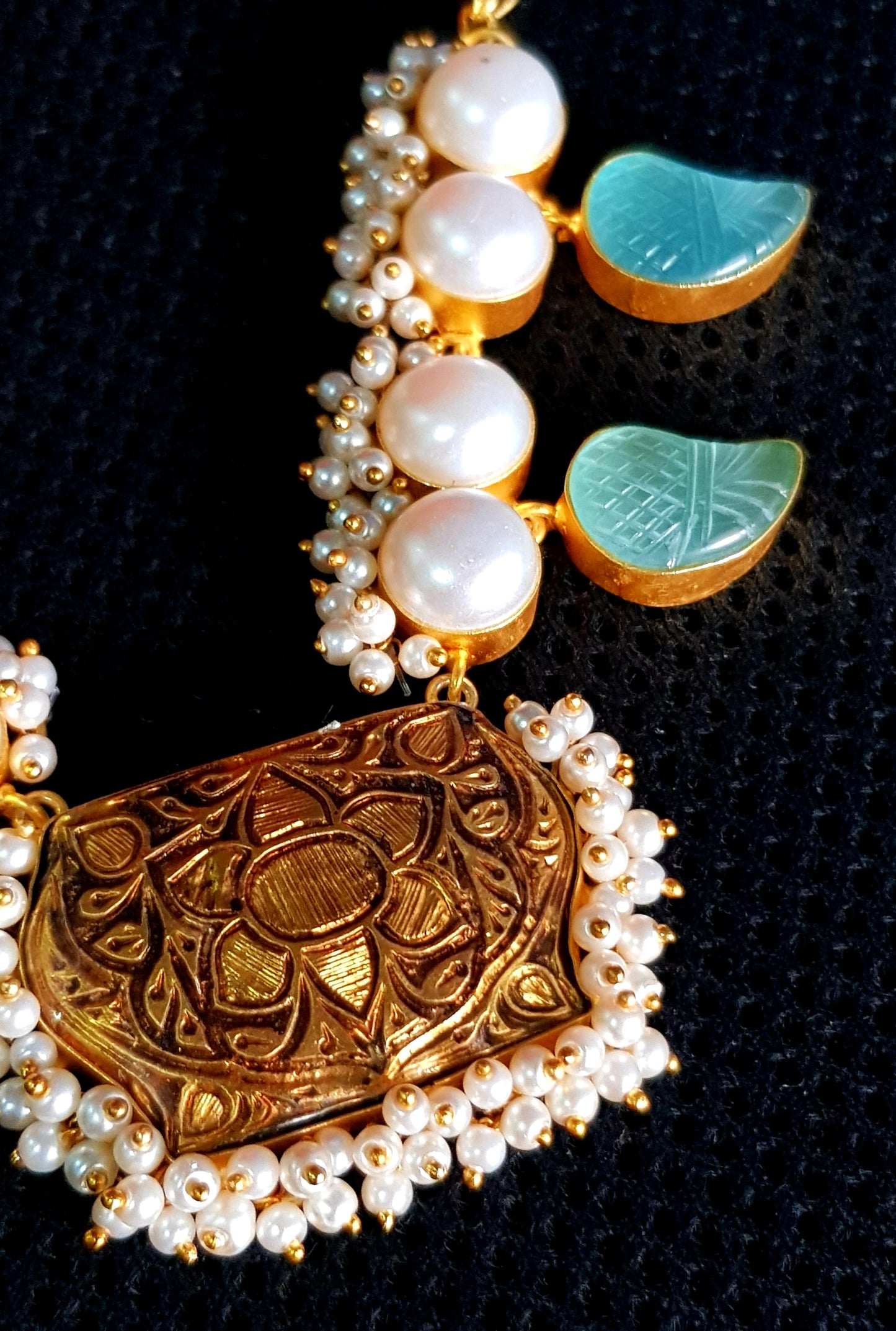 Neacklace in gold finish with black meenakari pendant and paisley design aqua blue stone