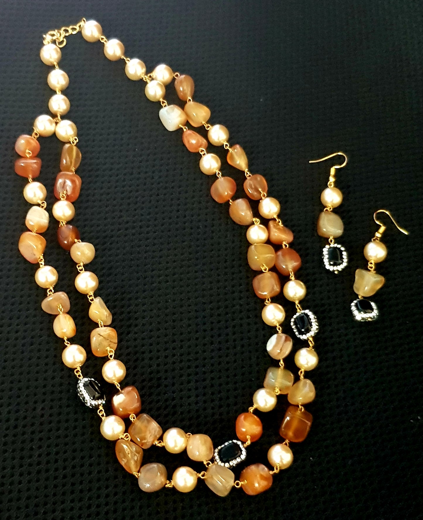 Set with a double string necklace with pearls,black stone,multicolour stones, matching earrings