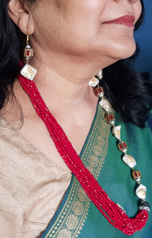 Set with rectangular metal beads in red/green interspaced with Baroque pearls in one half and multiple red and green stone strings on the other,matching earring