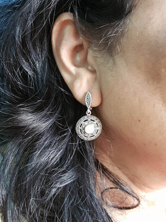 Silver hanging earrings, concentric circles with marcasite with pearl in center