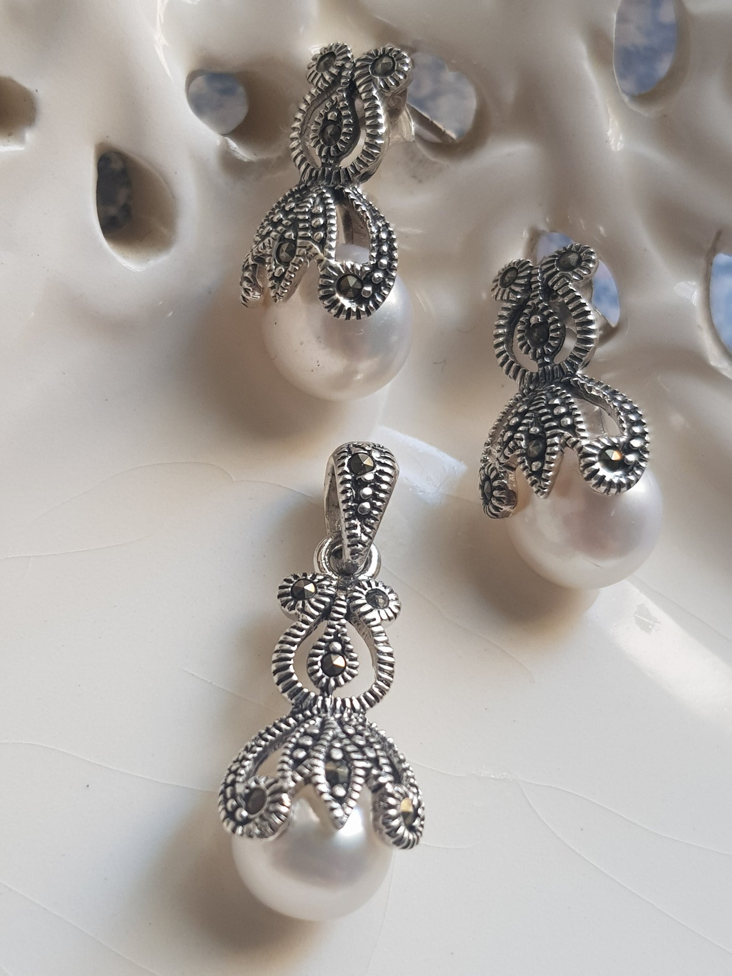 Silver pendant and earrings set with enclosed pearls design and marcasite