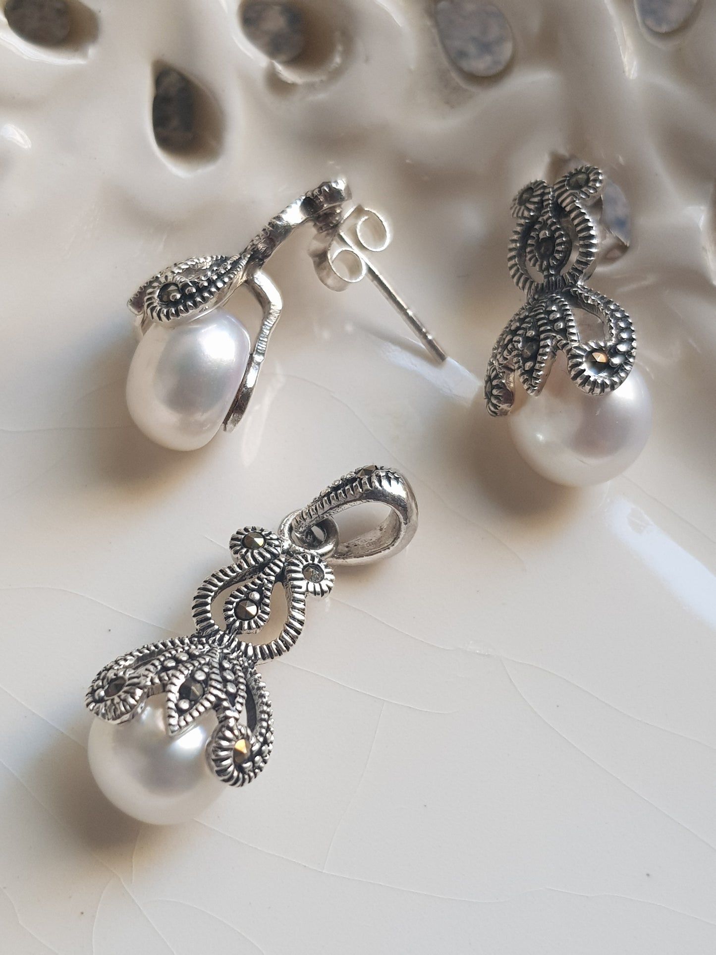 Silver pendant and earrings set with enclosed pearls design and marcasite