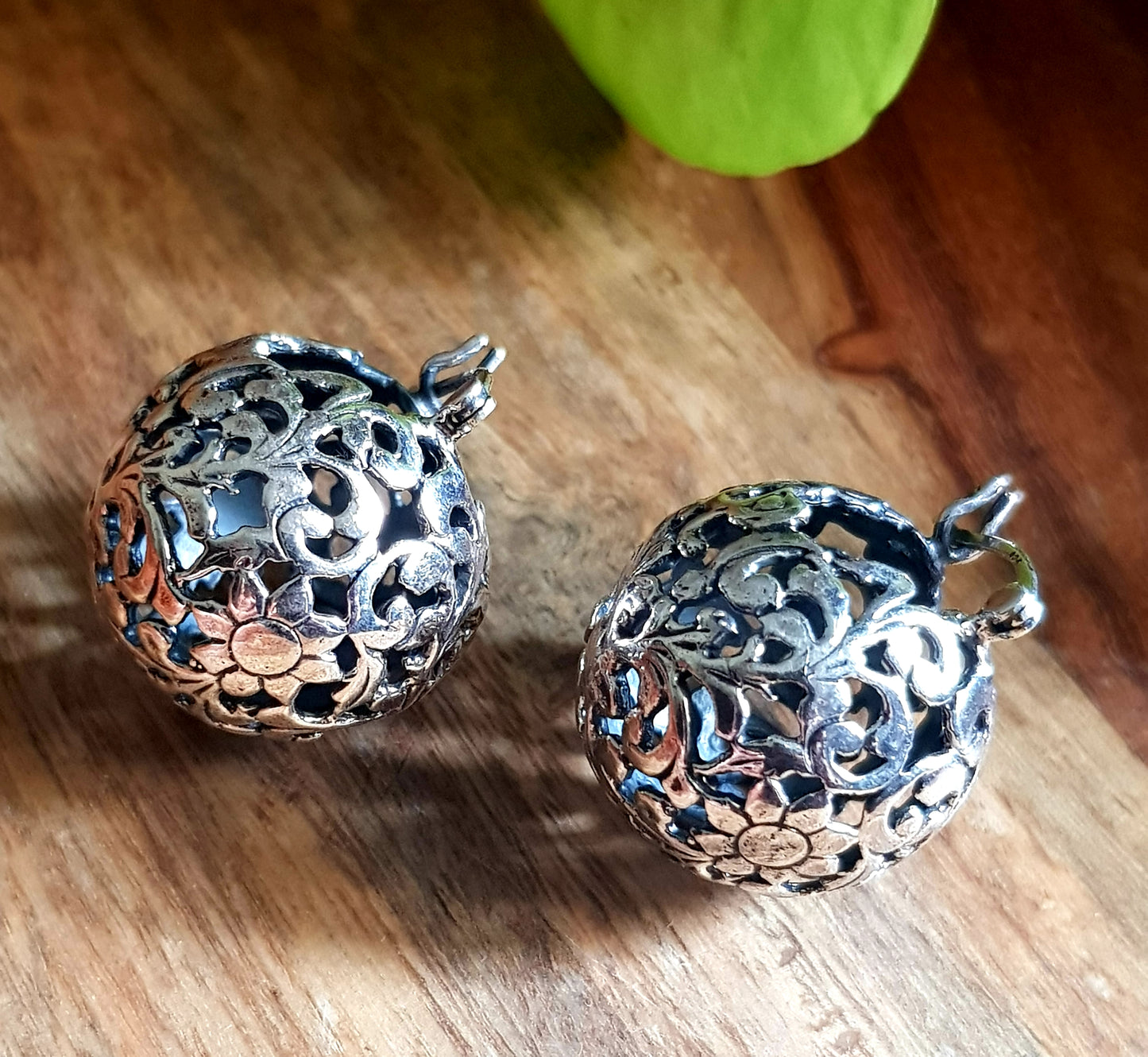 Silver earrings, globe shaped with intricate work, clasp lock system