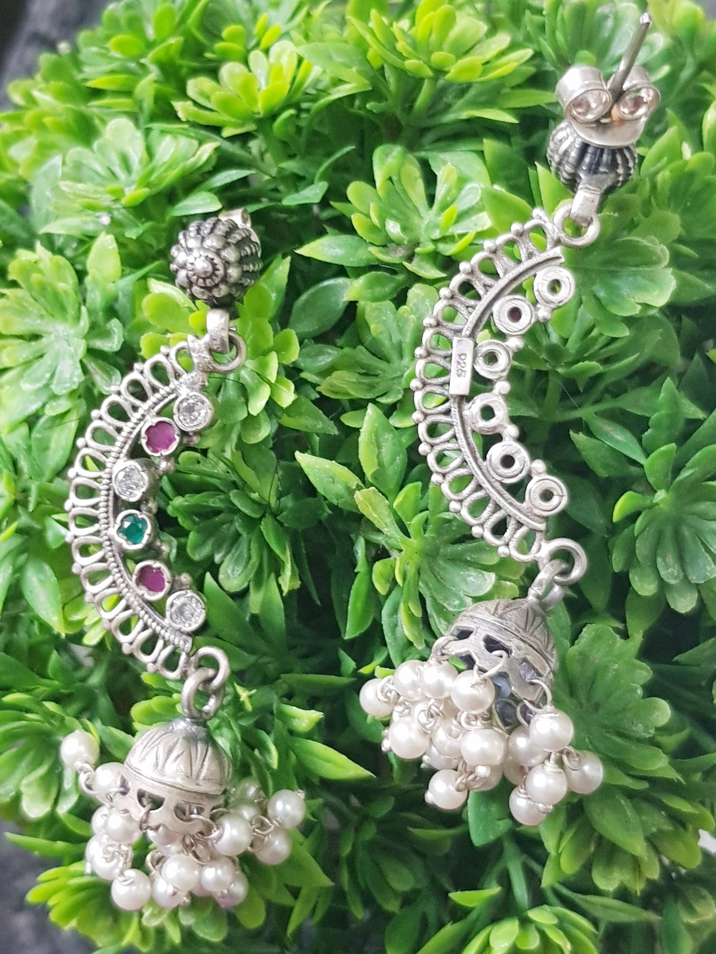 Silver earrings, C-shaped with stones detailing and small jhumka at the end with pearl beads