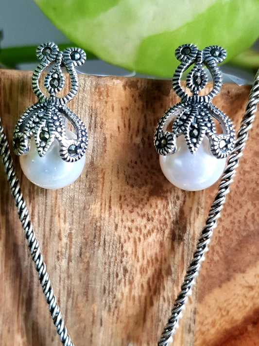 Silver pendant and earrings set with enclosed pearls design and marcasite