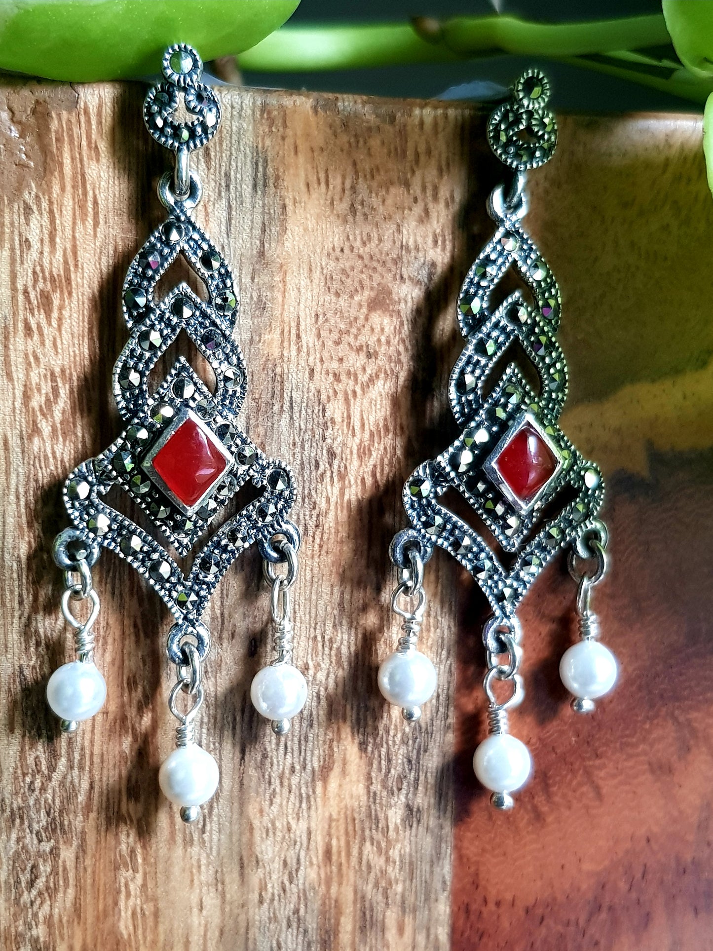 Silver danglers (earrings) with pearls at bottom and ruby in center