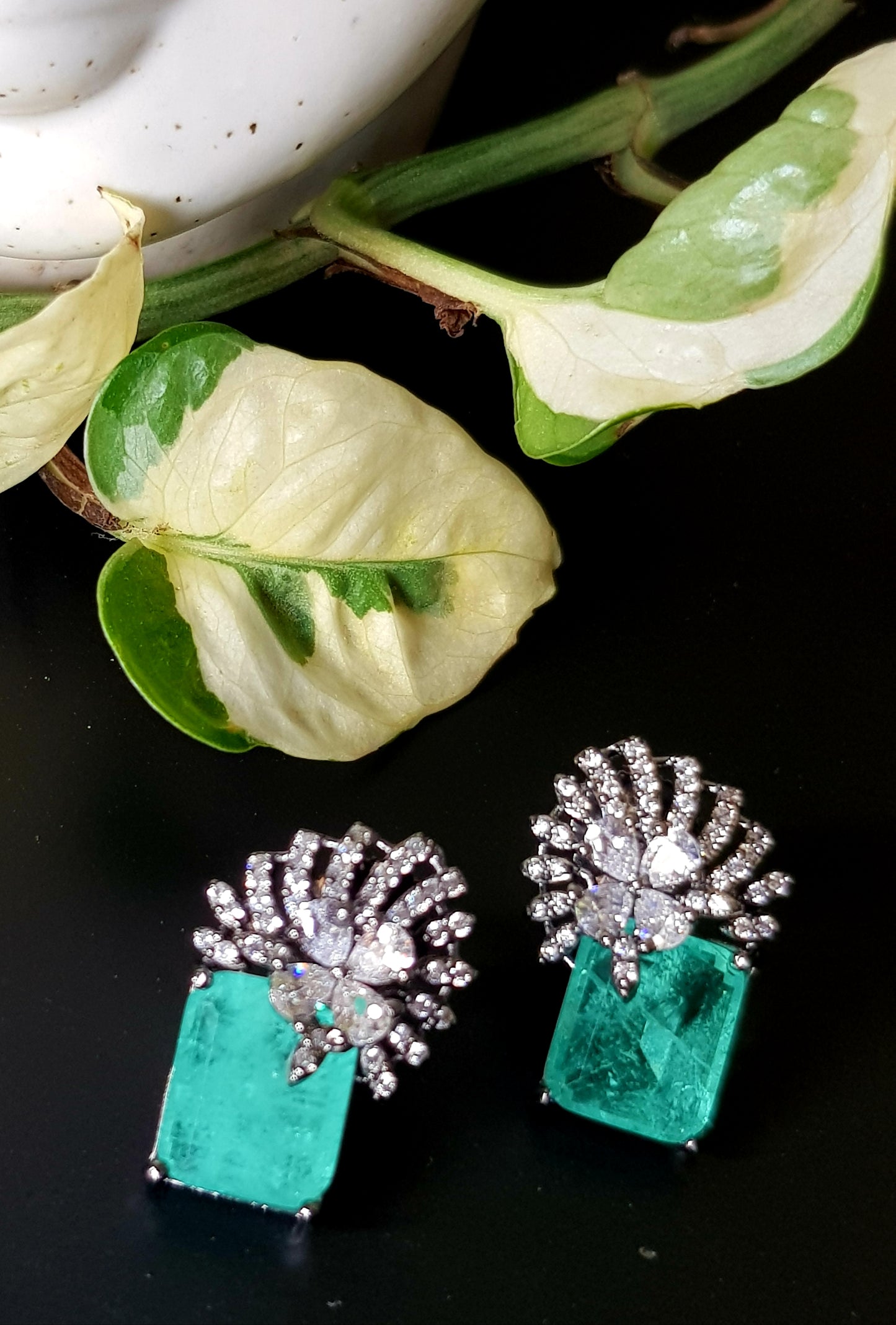 Victorian finish studs (earrings), teal green stone with flower design in CZ