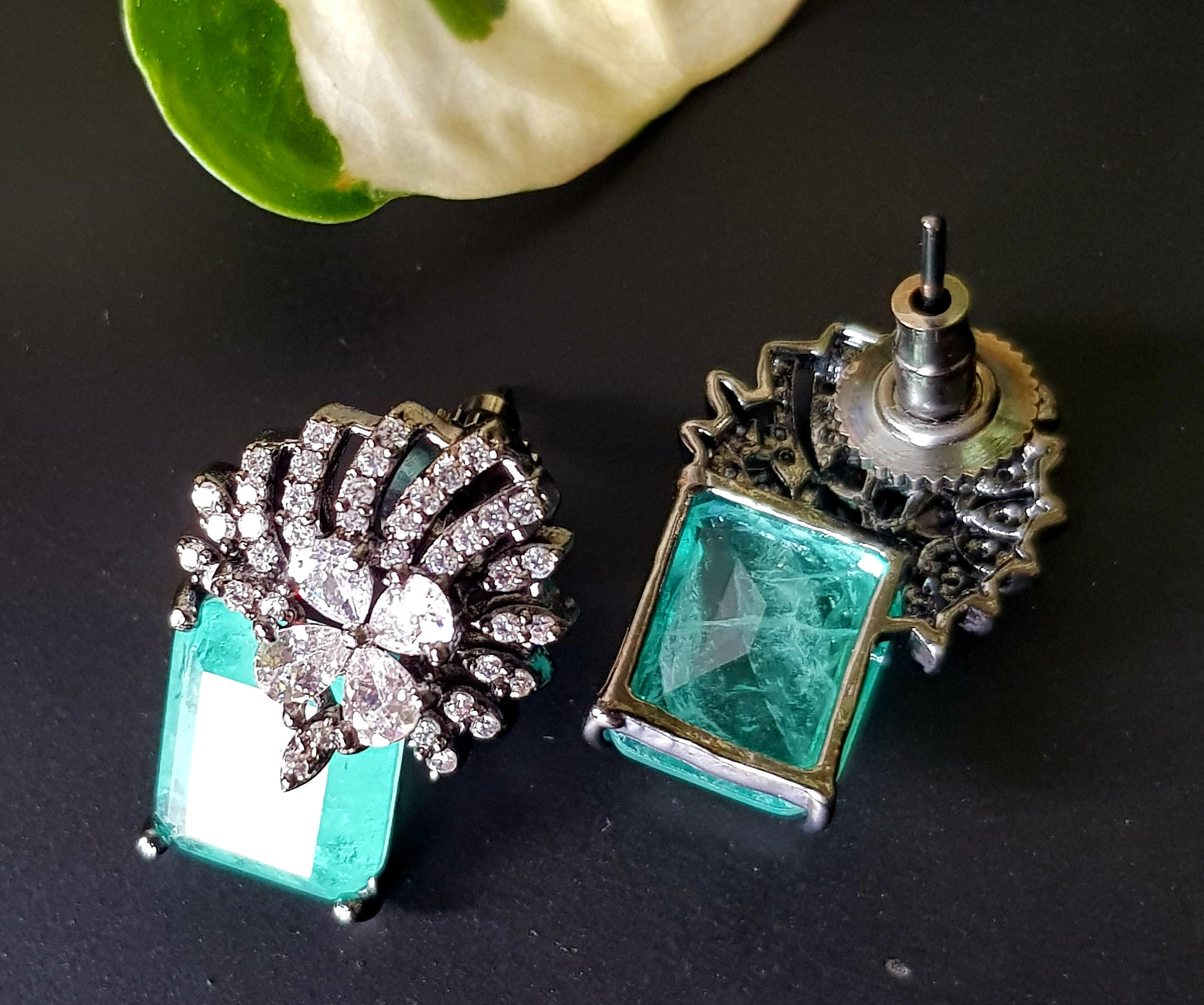 Victorian finish studs (earrings), teal green stone with flower design in CZ