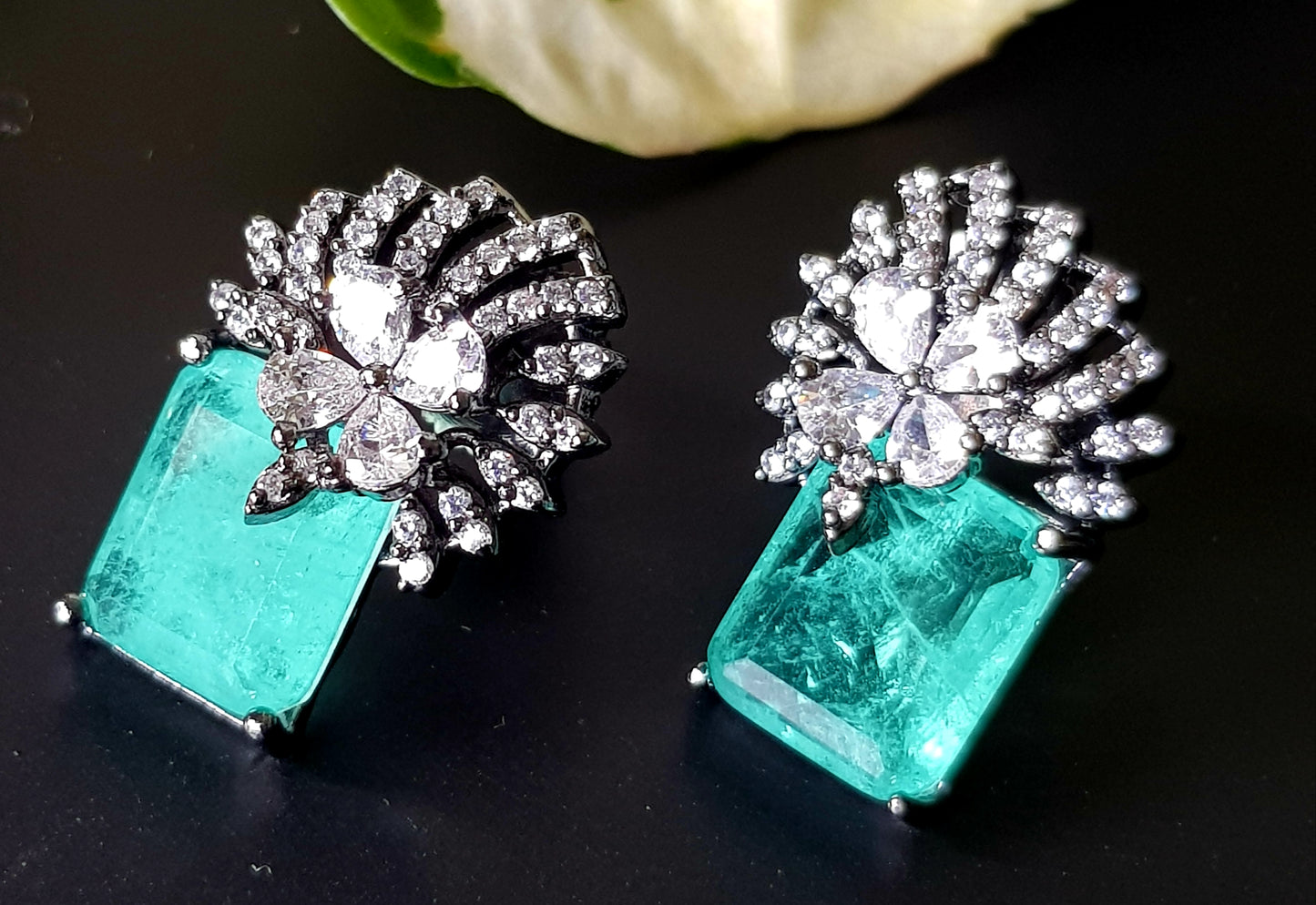 Victorian finish studs (earrings), teal green stone with flower design in CZ