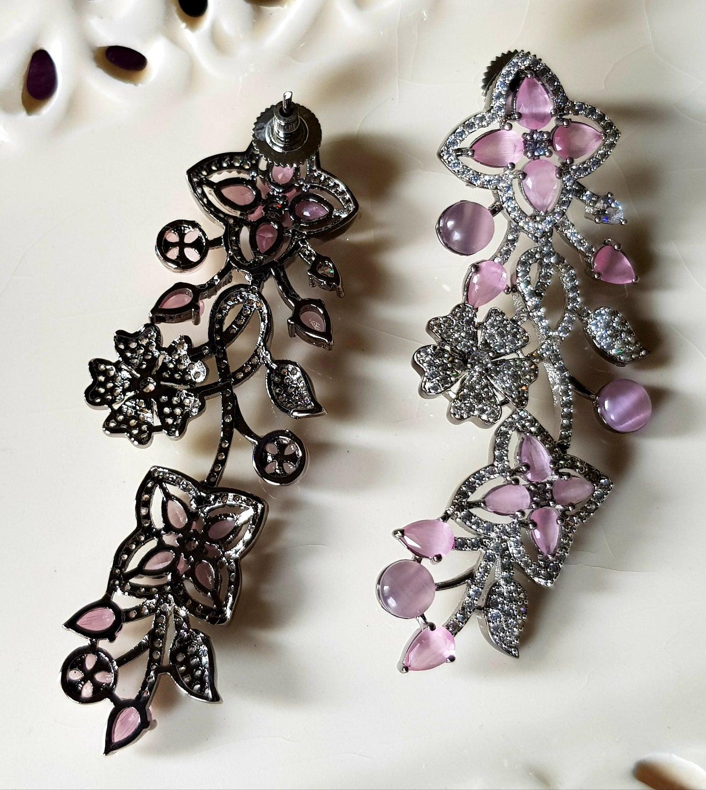 Platinum finish long studs (earrings), floral design in pale pink/sapphire and emerald stone detailing