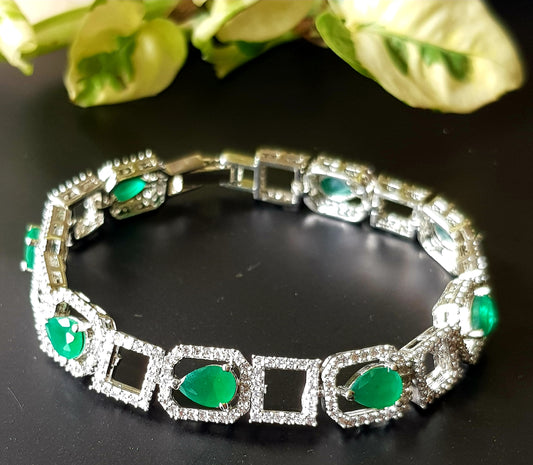 Platinum finish bracelet with teardrop emeralds framed with CZ