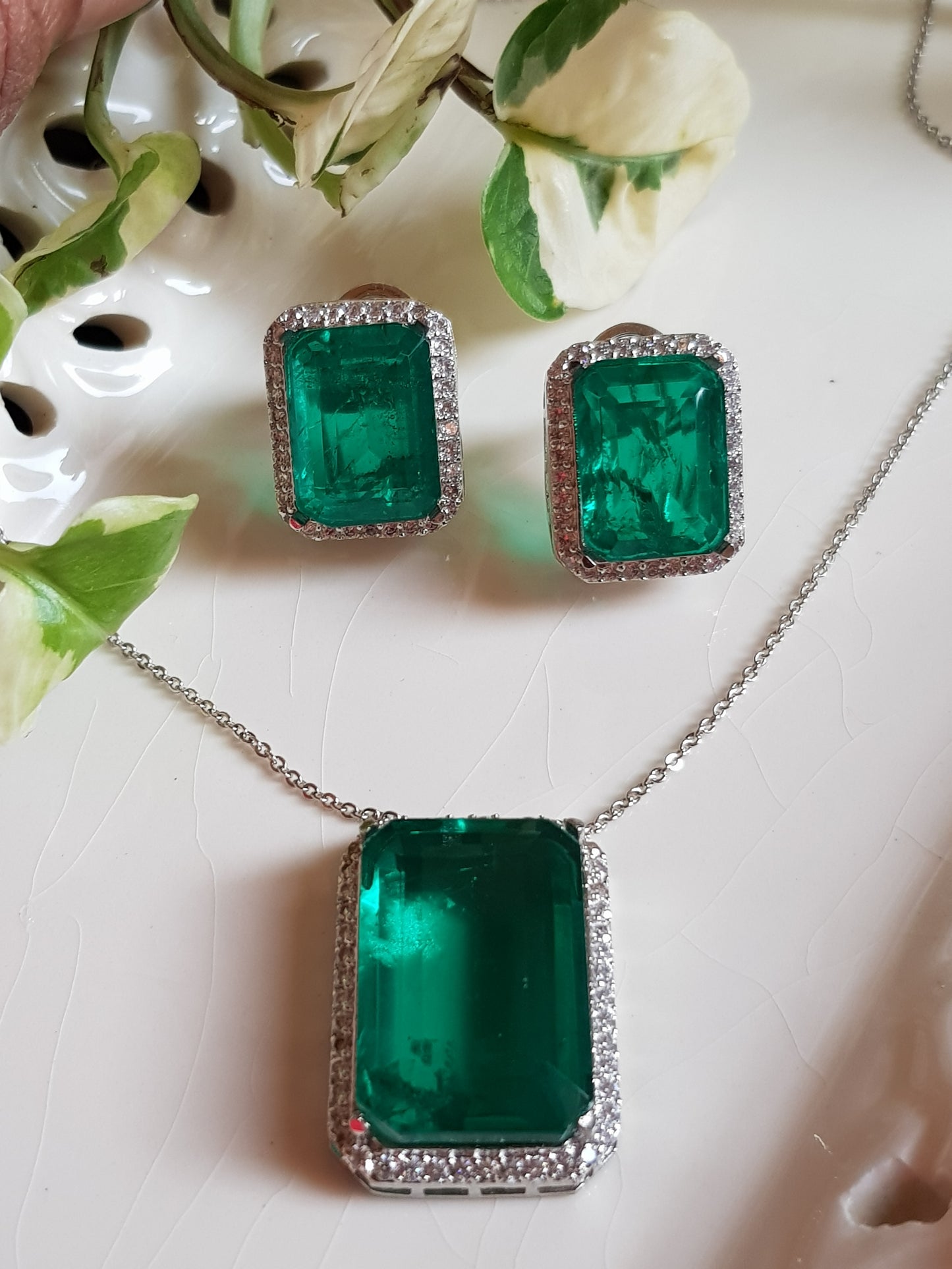 Platinum finish single stone emerald pendant set, matching studs (earrings)