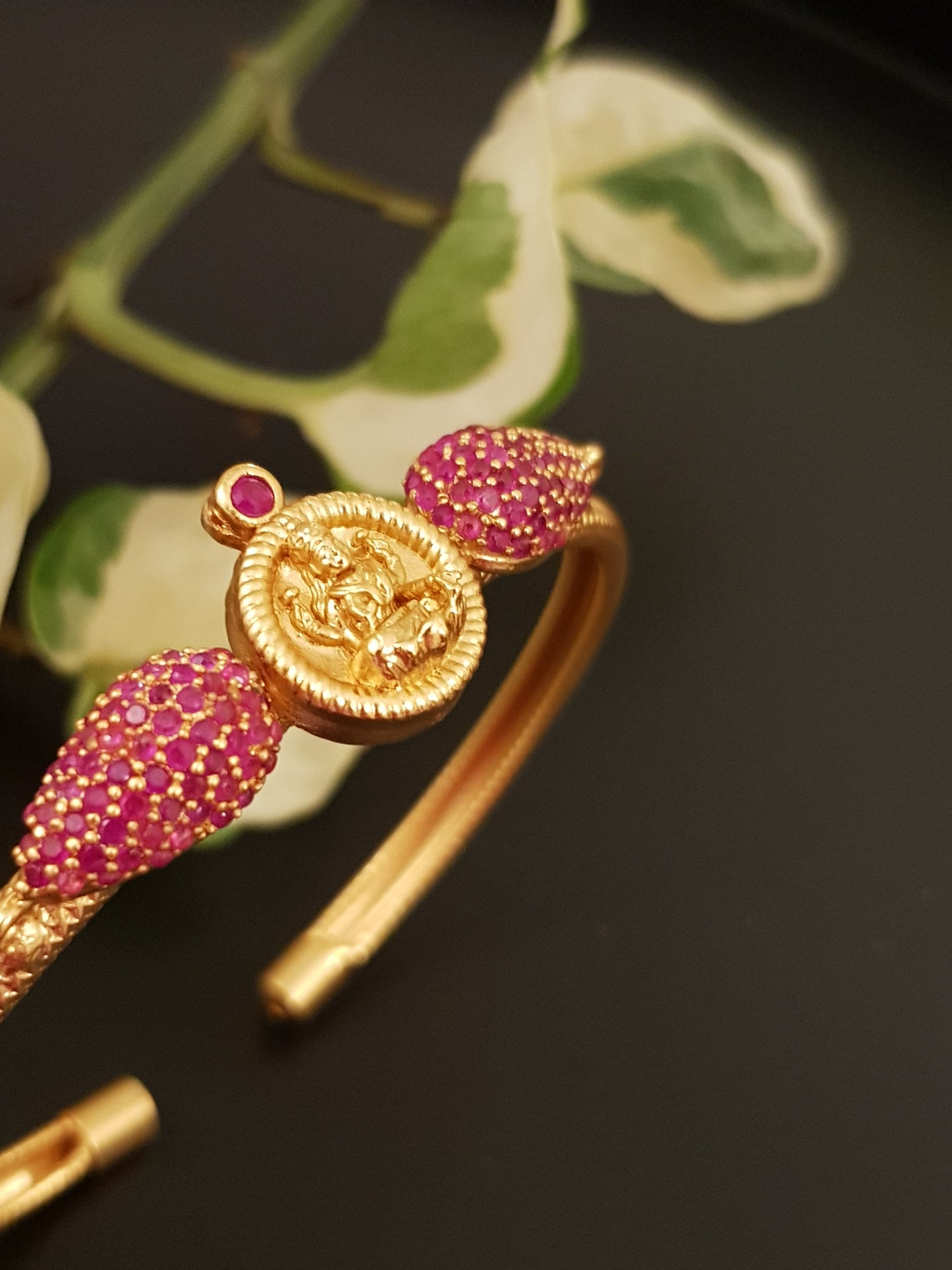 Temple jewelry gold finish bracelet with lakshmi motif and ruby stone detailing