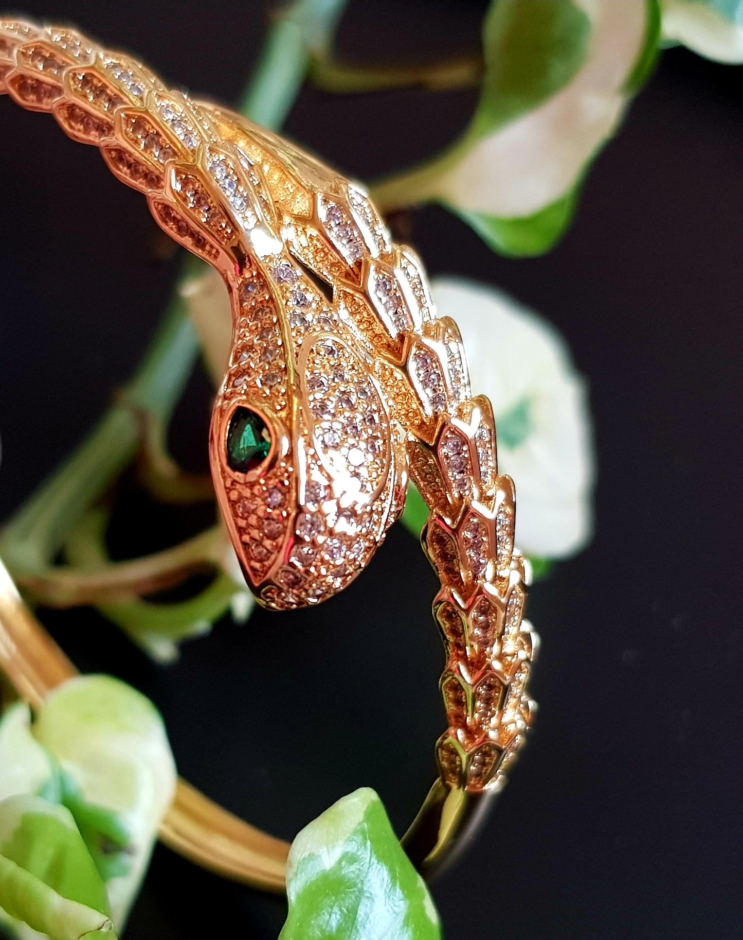 Snake shaped gold finish bracelet with emerald stone eye, embellished with CZ