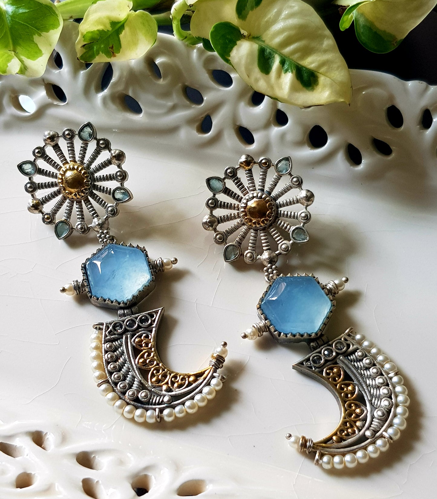 Earrings with pale blue stones in dual tone