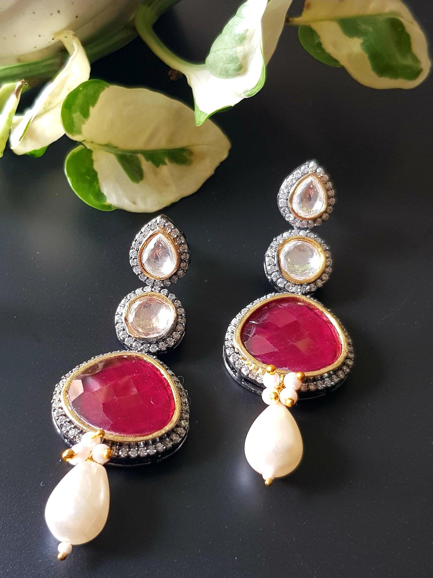 Antique silver finish earrings with ruby red/green stone on kundan hangings surrounded by CZ