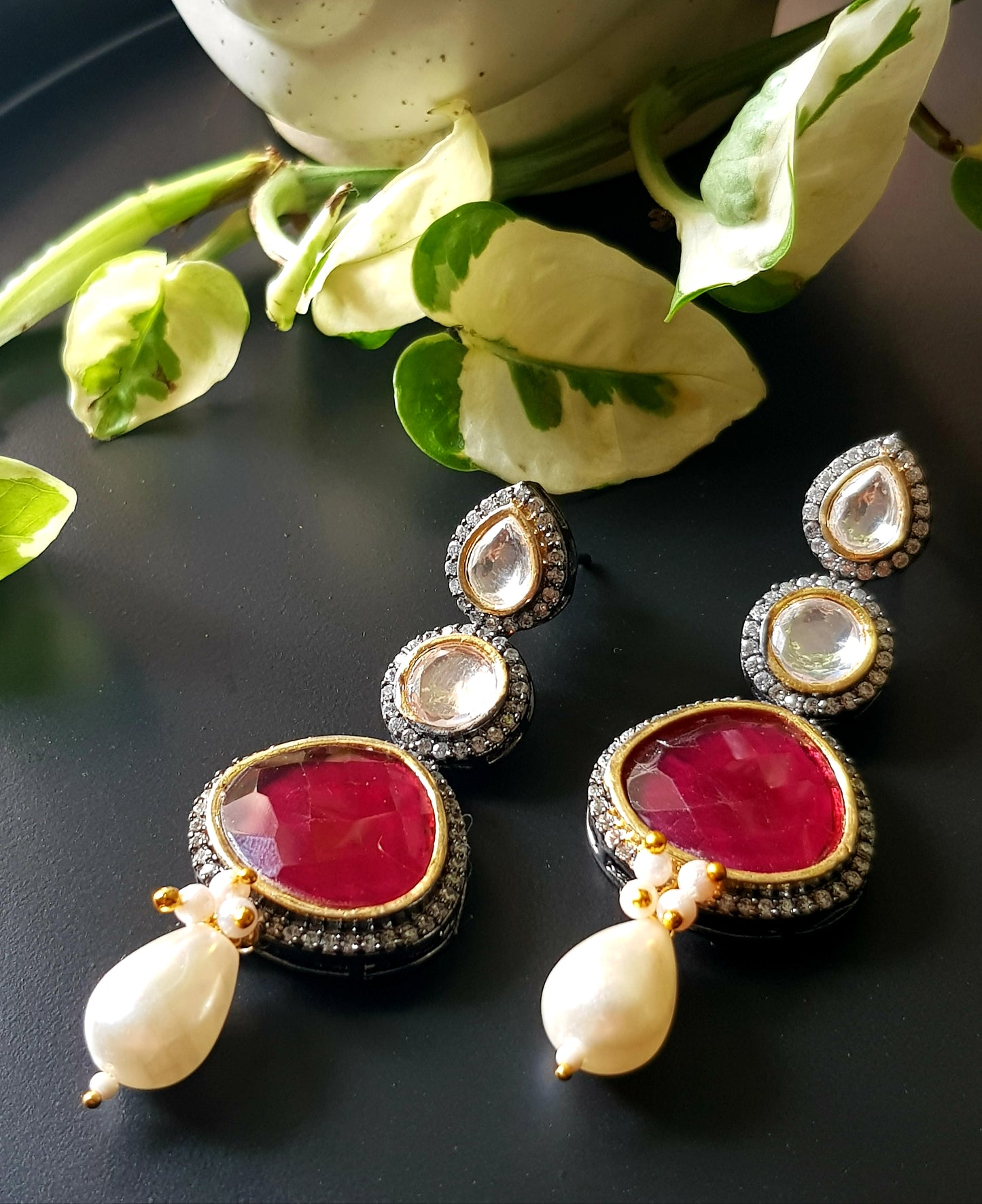 Antique silver finish earrings with ruby red/green stone on kundan hangings surrounded by CZ