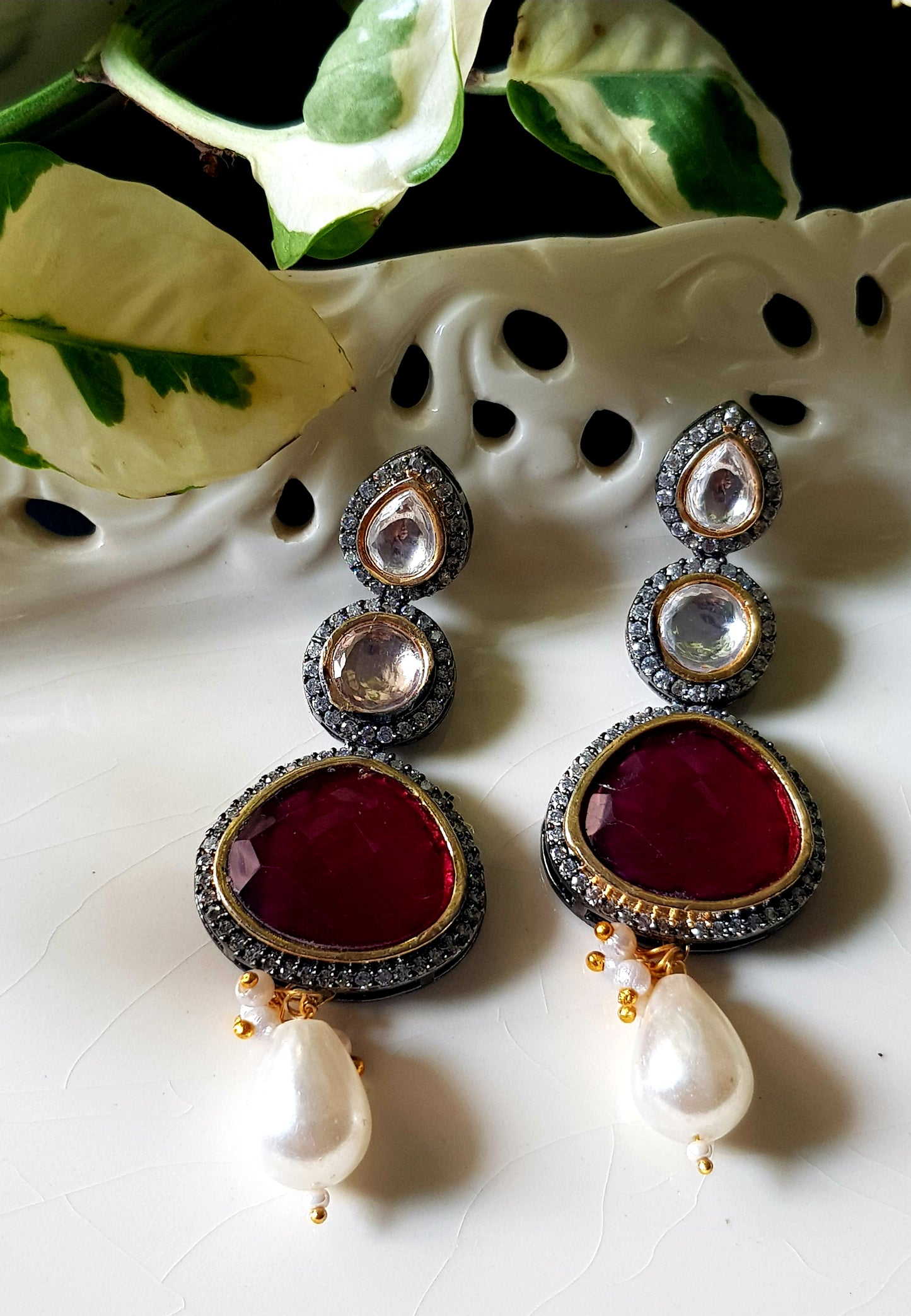 Antique silver finish earrings with ruby red/green stone on kundan hangings surrounded by CZ