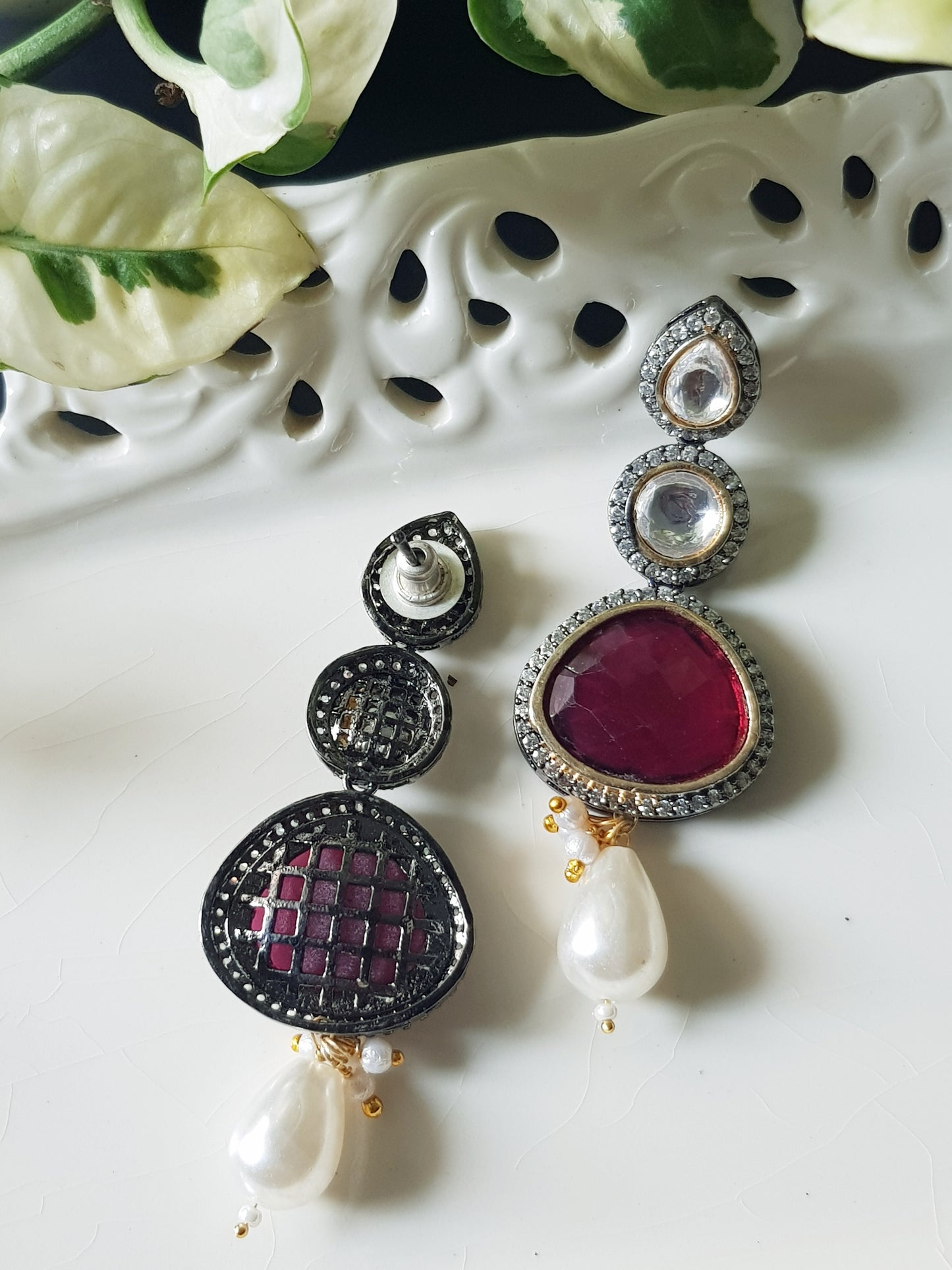 Antique silver finish earrings with ruby red/green stone on kundan hangings surrounded by CZ