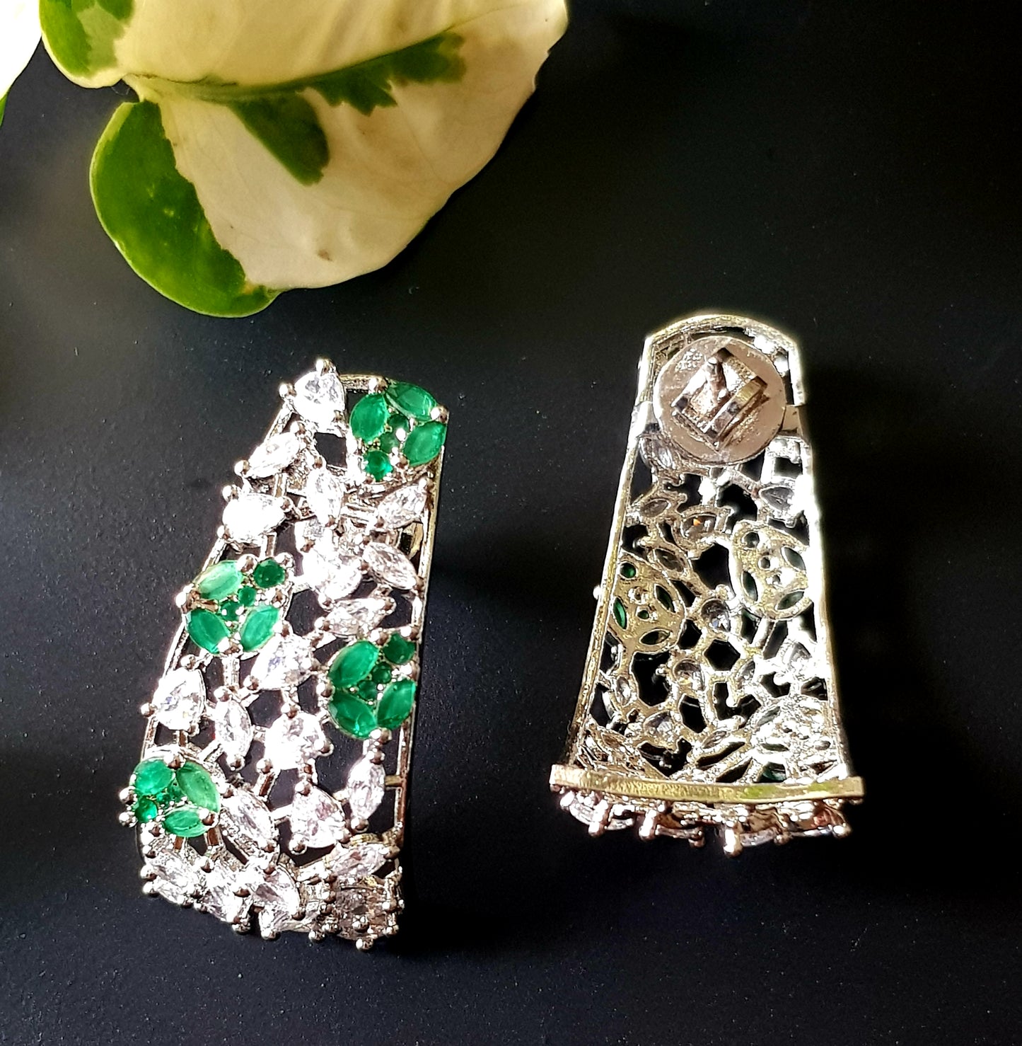 Platinum finish with CZ and emerald, jaali design big studs (earrings)