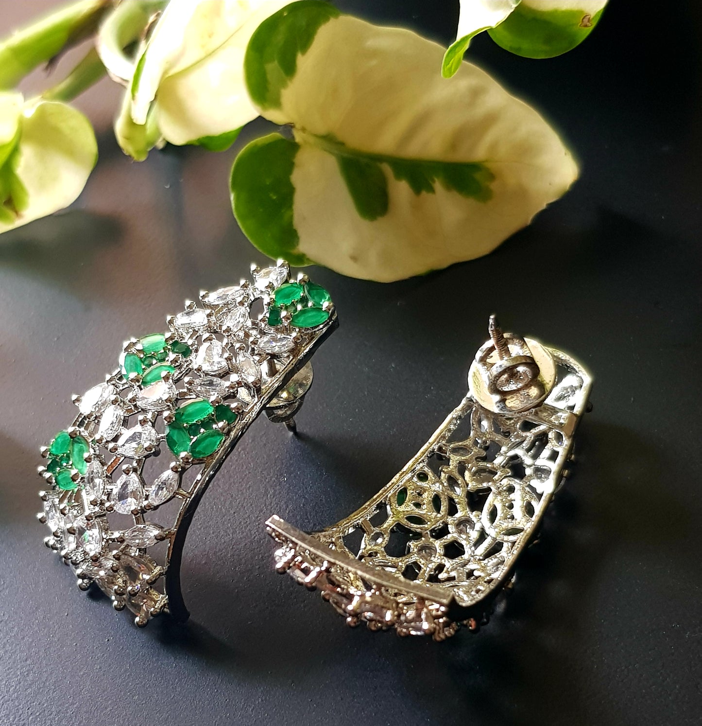 Platinum finish with CZ and emerald, jaali design big studs (earrings)