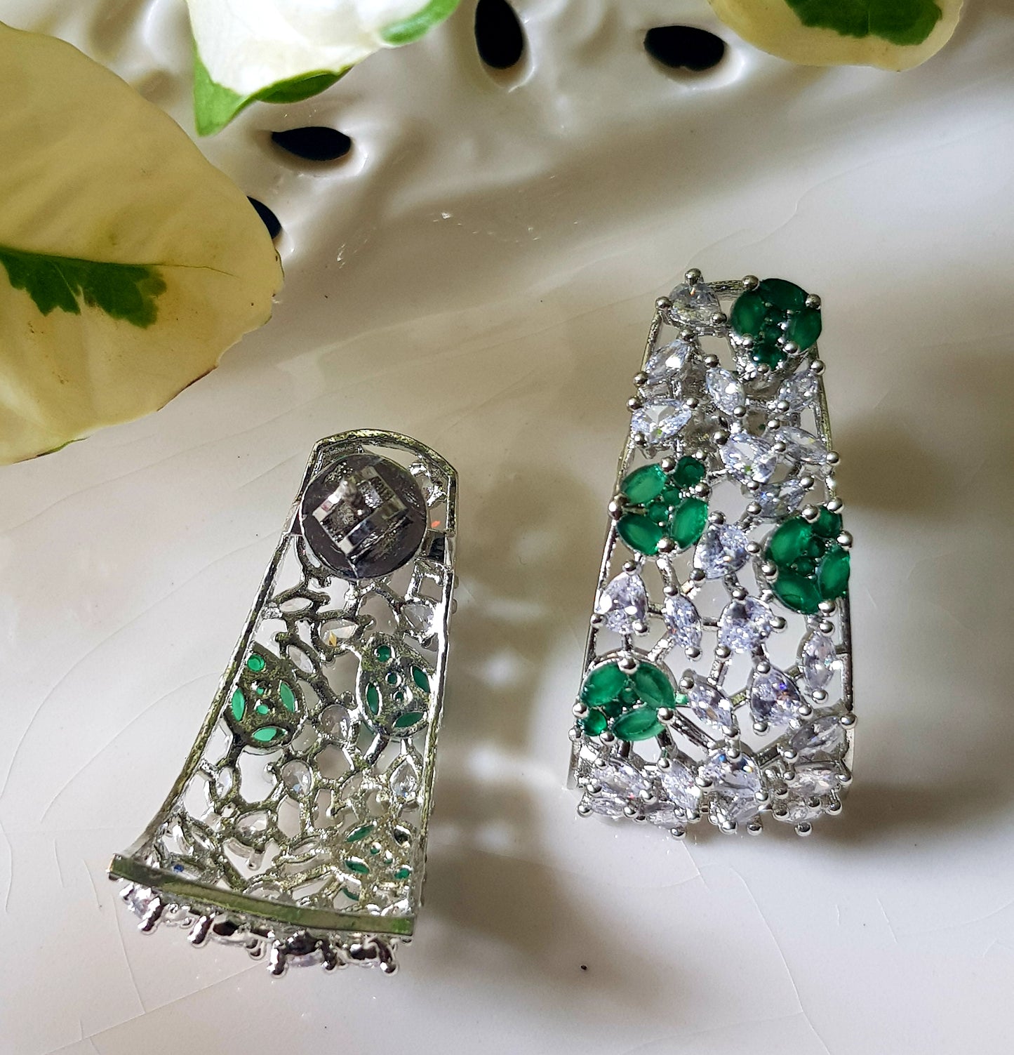 Platinum finish with CZ and emerald, jaali design big studs (earrings)