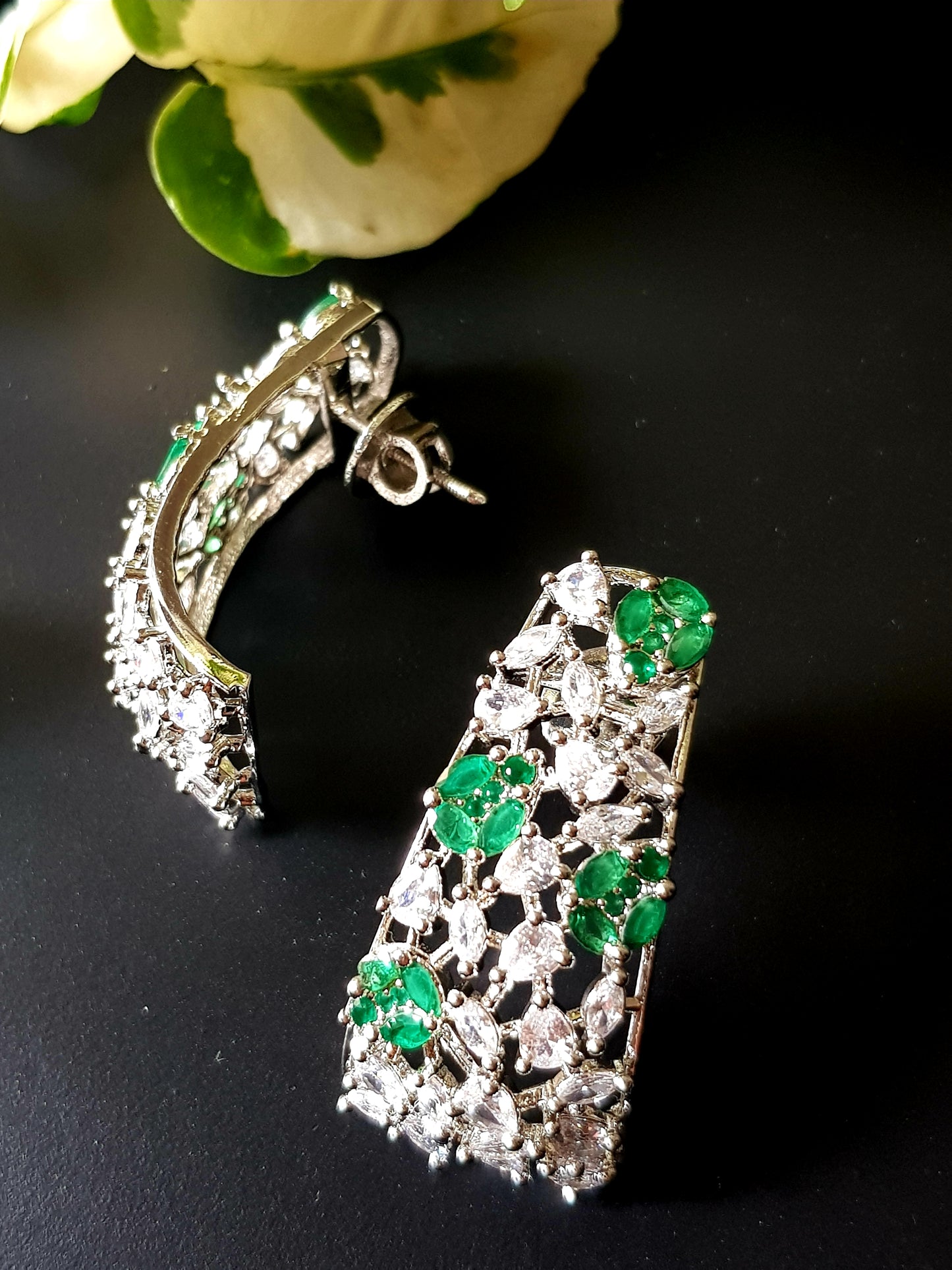 Platinum finish with CZ and emerald, jaali design big studs (earrings)