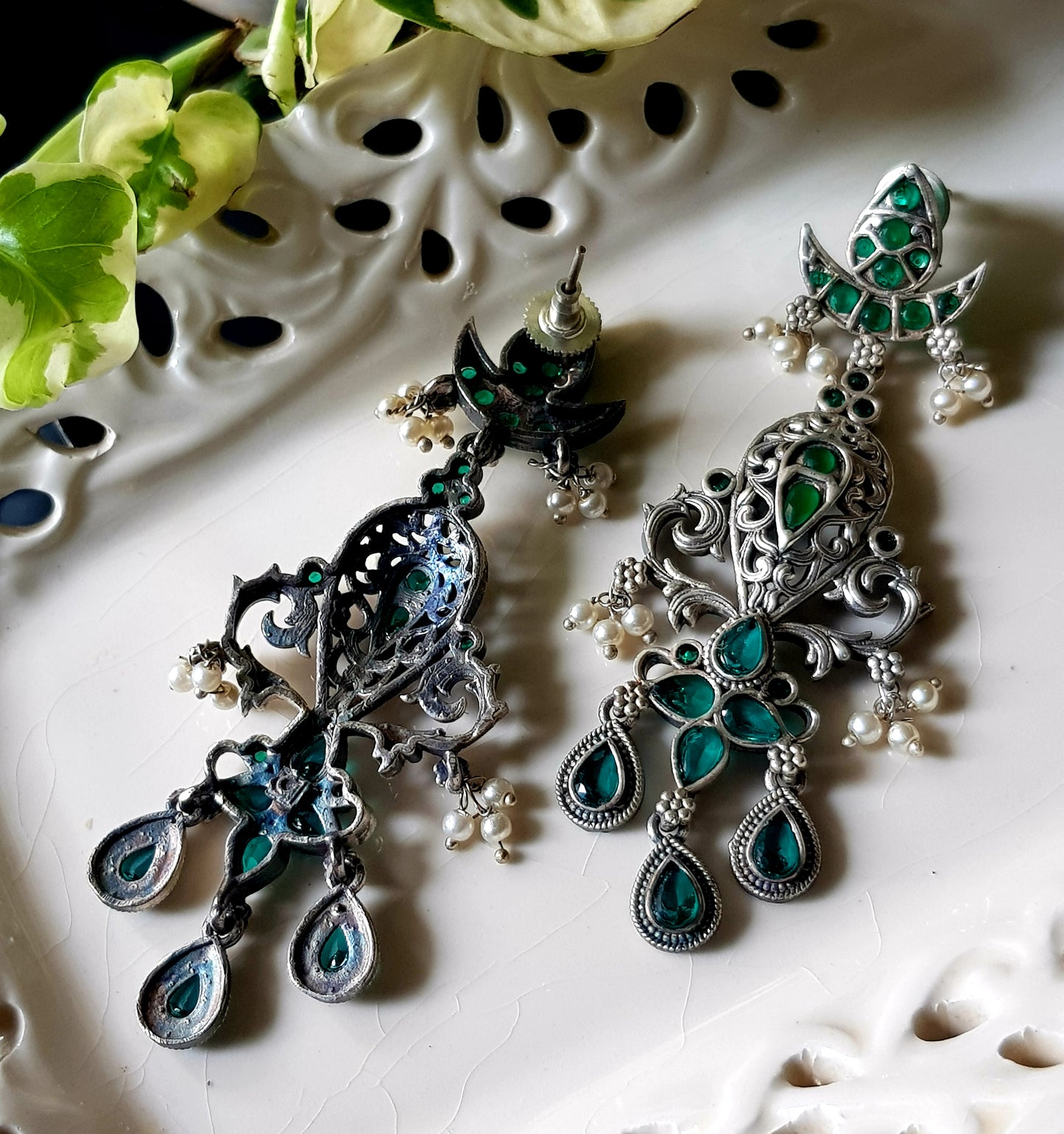 Silver finish long earrings with emerald stone detailing