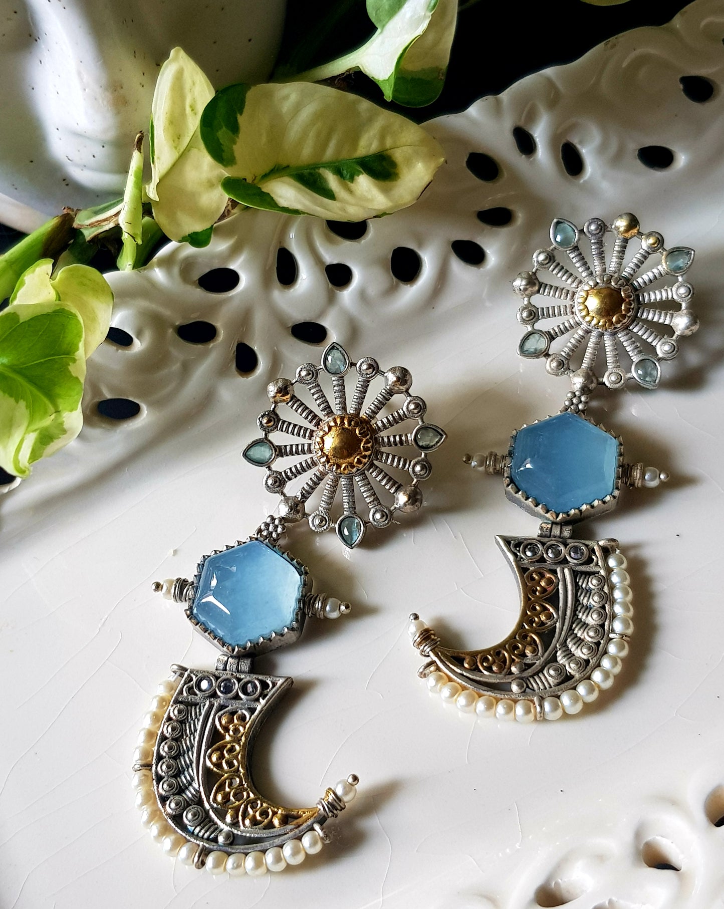 Earrings with pale blue stones in dual tone