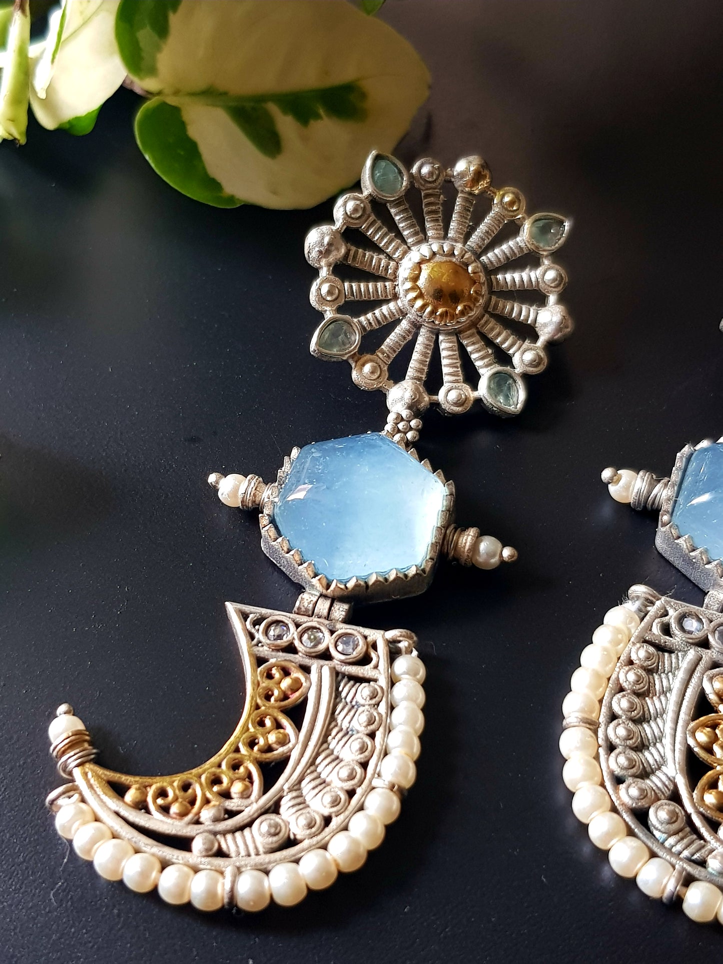 Earrings with pale blue stones in dual tone