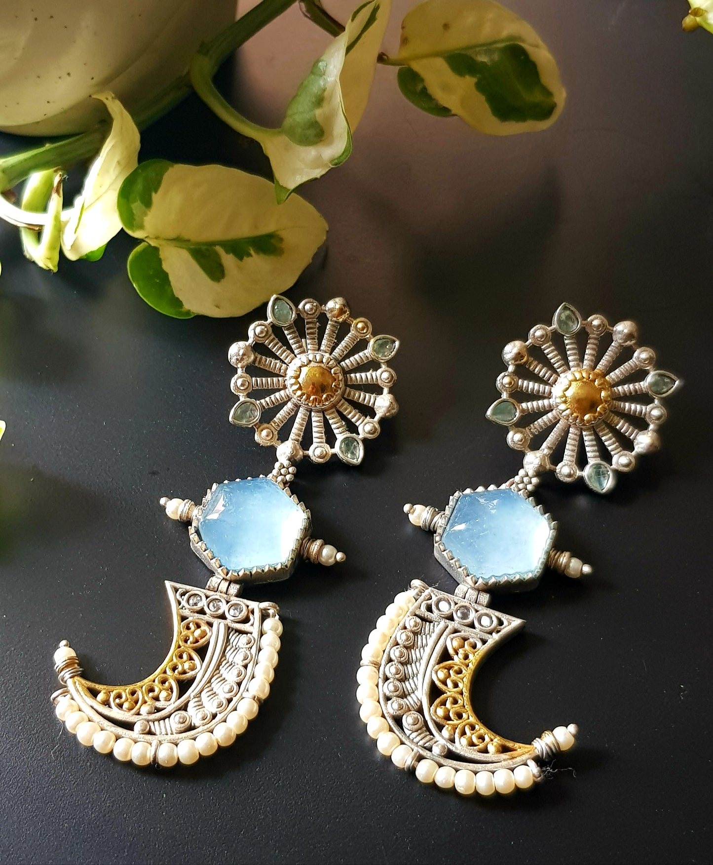 Earrings with pale blue stones in dual tone