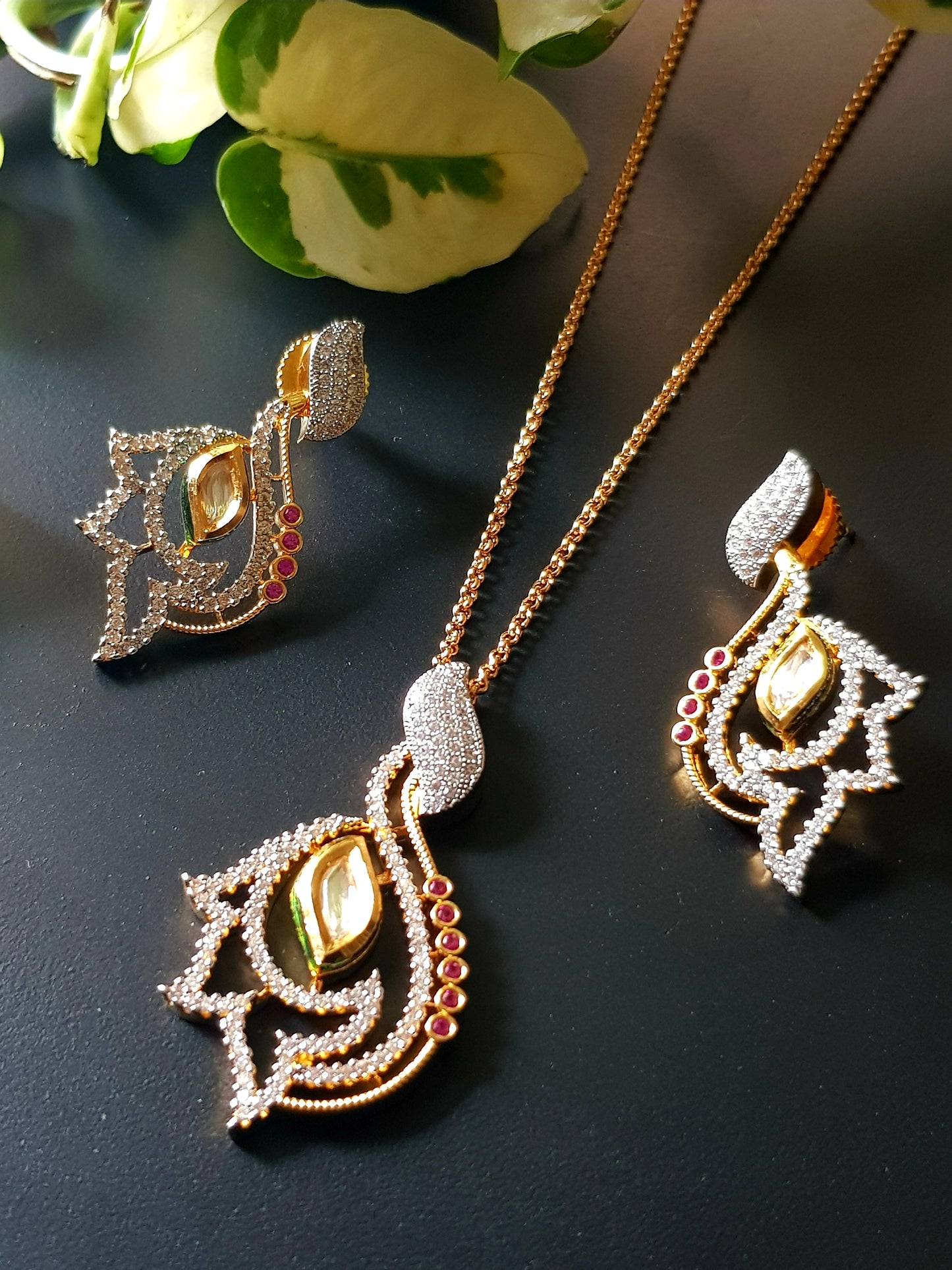 Gold finish pendant set, pendant has kundan stone, CZ and small ruby stones, matching studs (earrings)