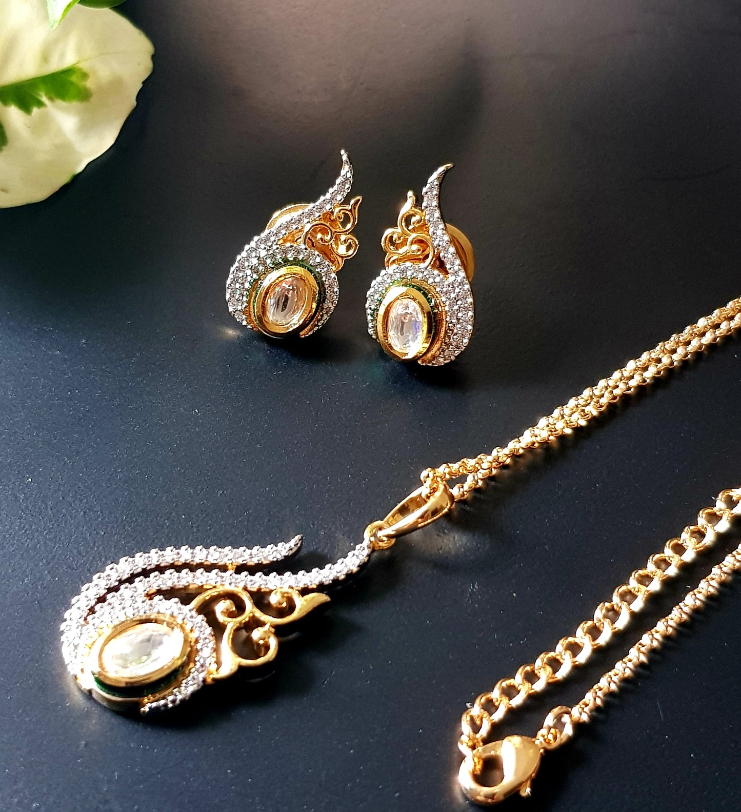 Gold finish pendant set, conch shell shape inspired pendant with kundan stone and embellished CZ, matching studs (earrings)