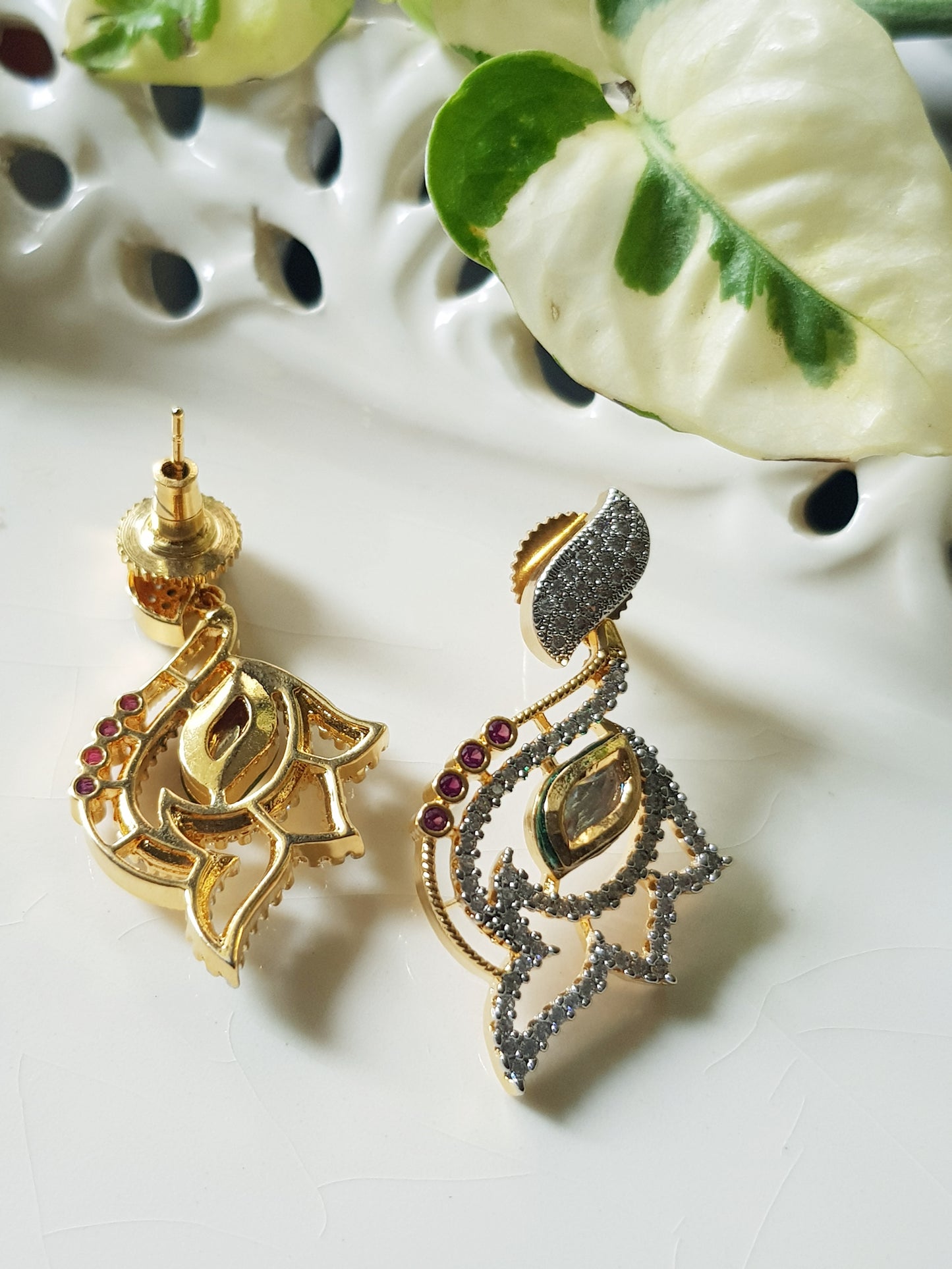 Gold finish pendant set, pendant has kundan stone, CZ and small ruby stones, matching studs (earrings)