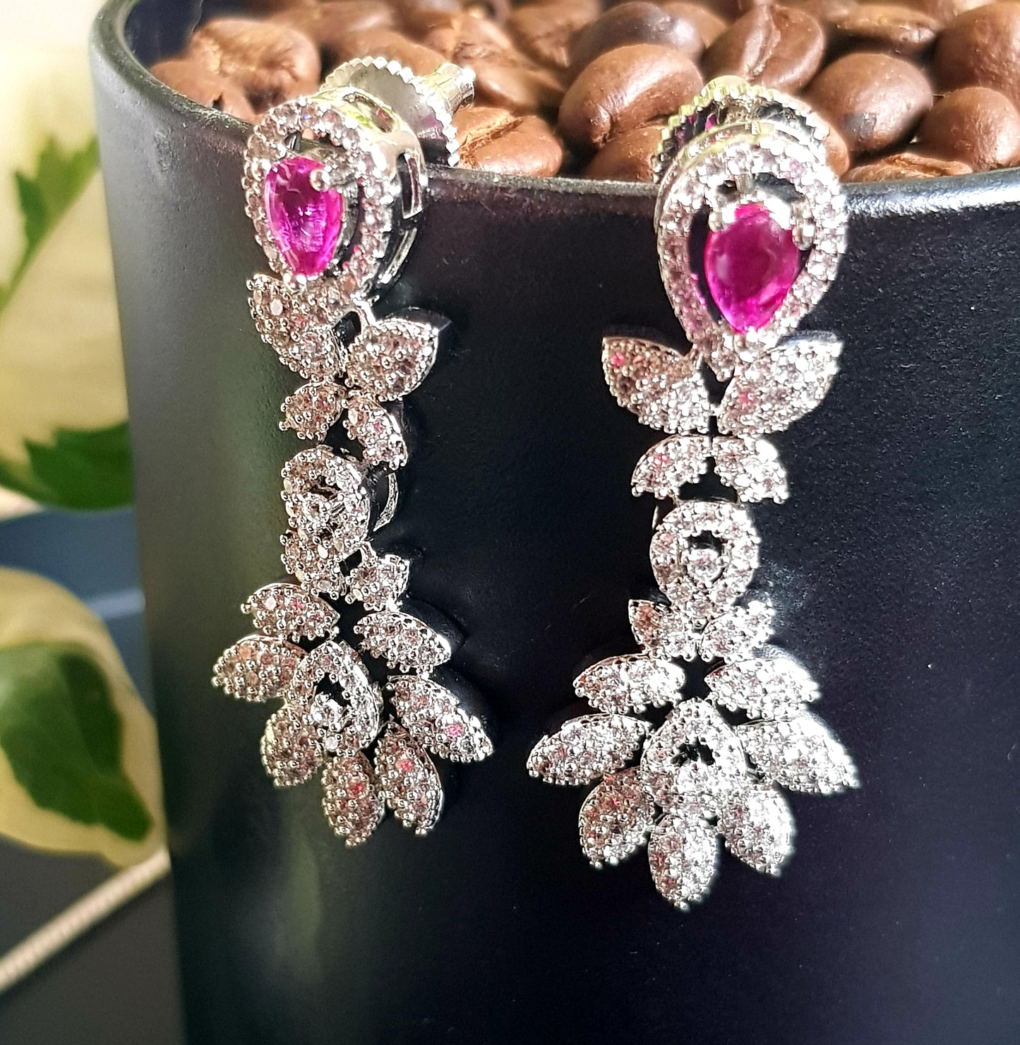 Platinum finish single strand set in leaf inspired CZ design and teardrop shaped ruby/emerald stone pendant, matching earrings