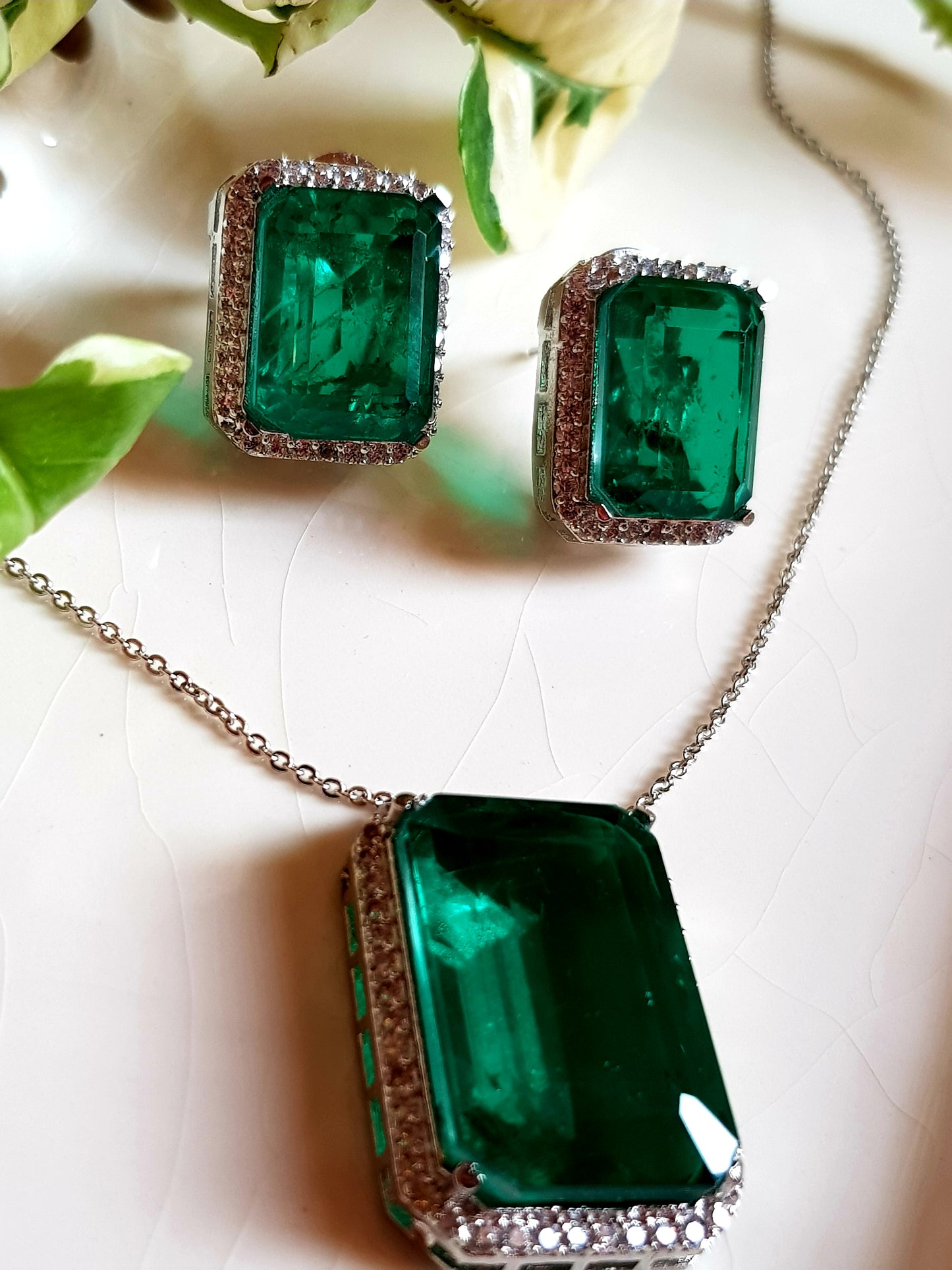 Platinum finish single stone emerald pendant set, matching studs (earrings)