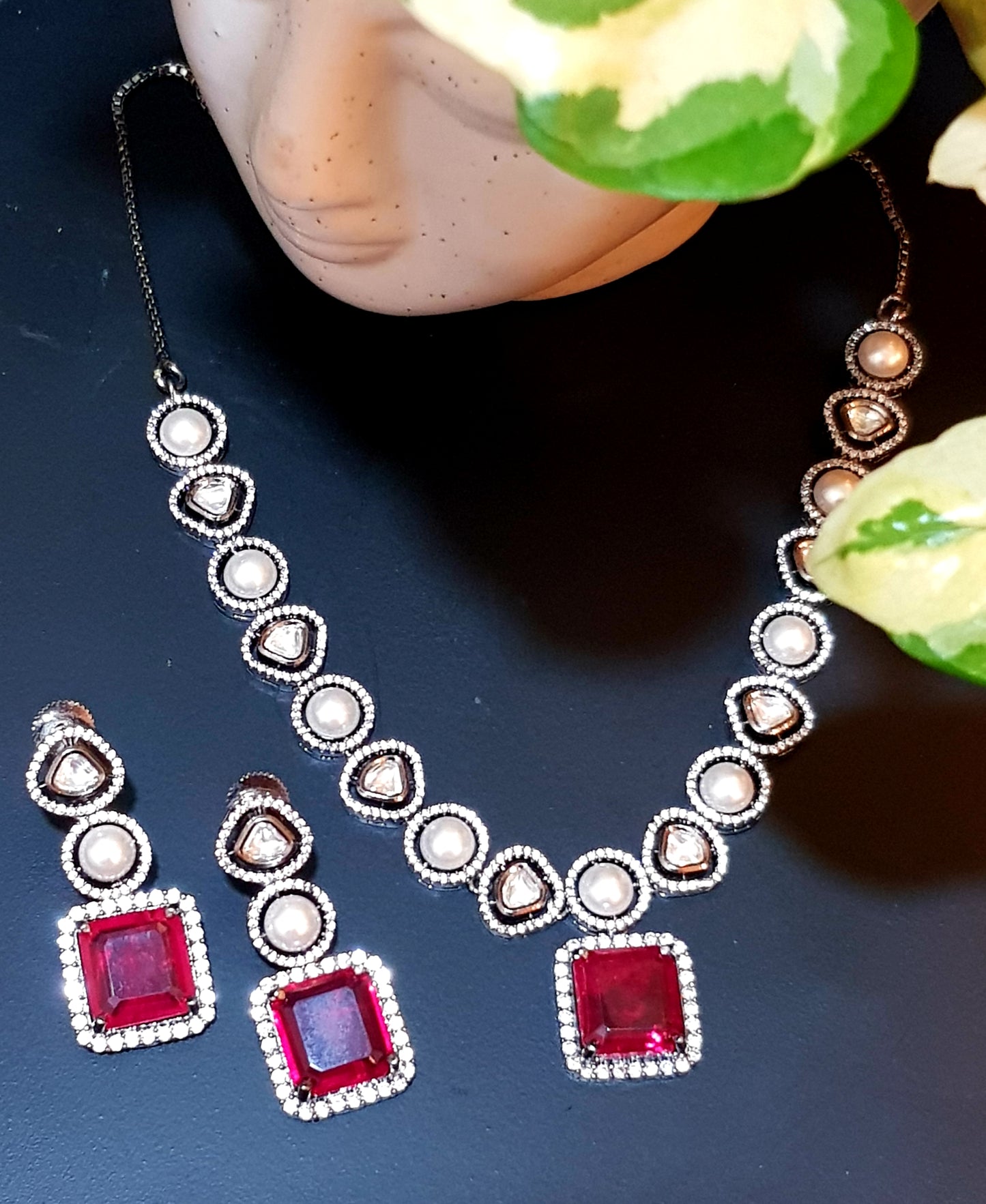 Antique silver finish set with square shaped ruby pendant on Kundan and pearl strand,matching earrings