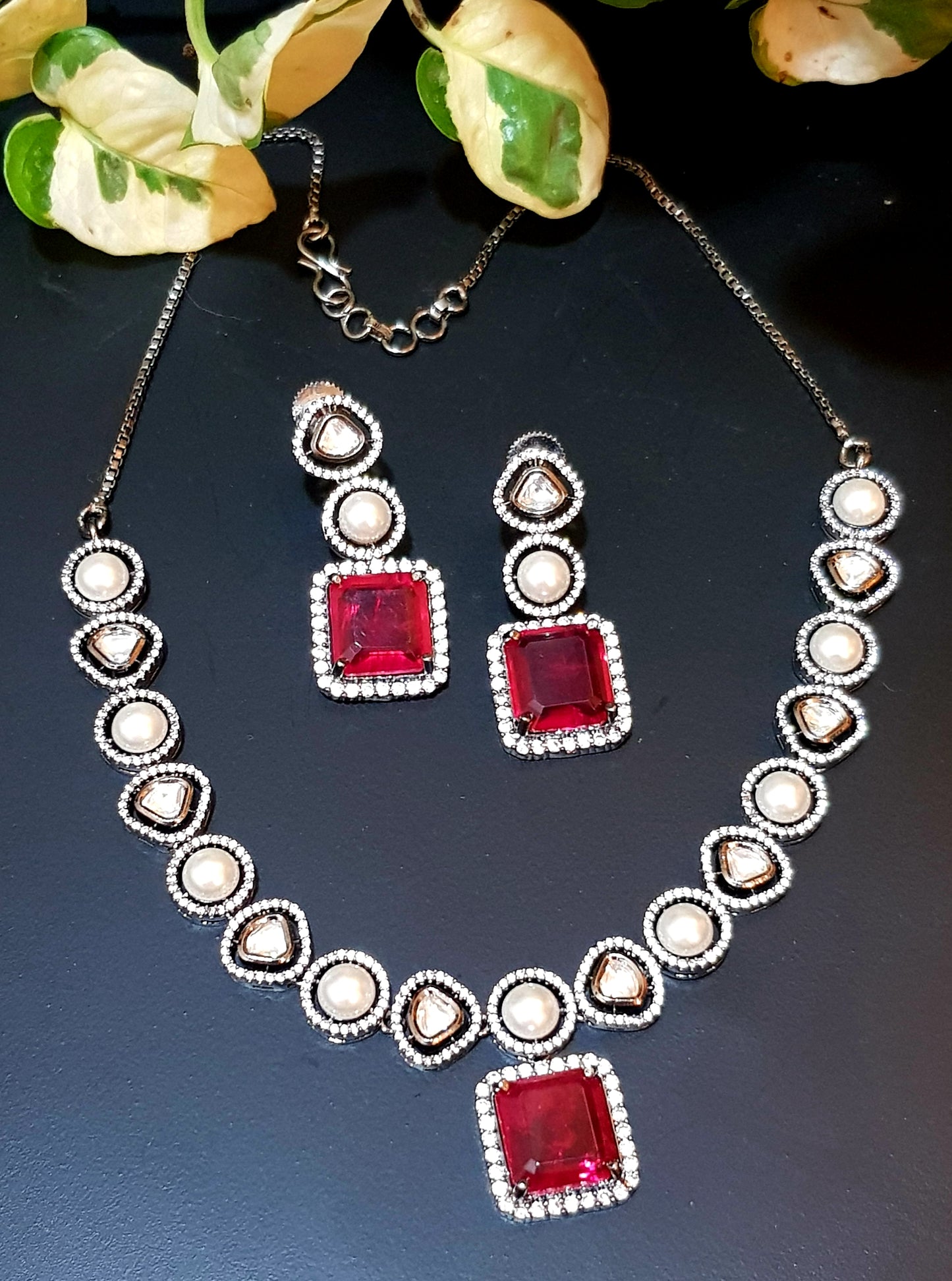 Antique silver finish set with square shaped ruby pendant on Kundan and pearl strand,matching earrings