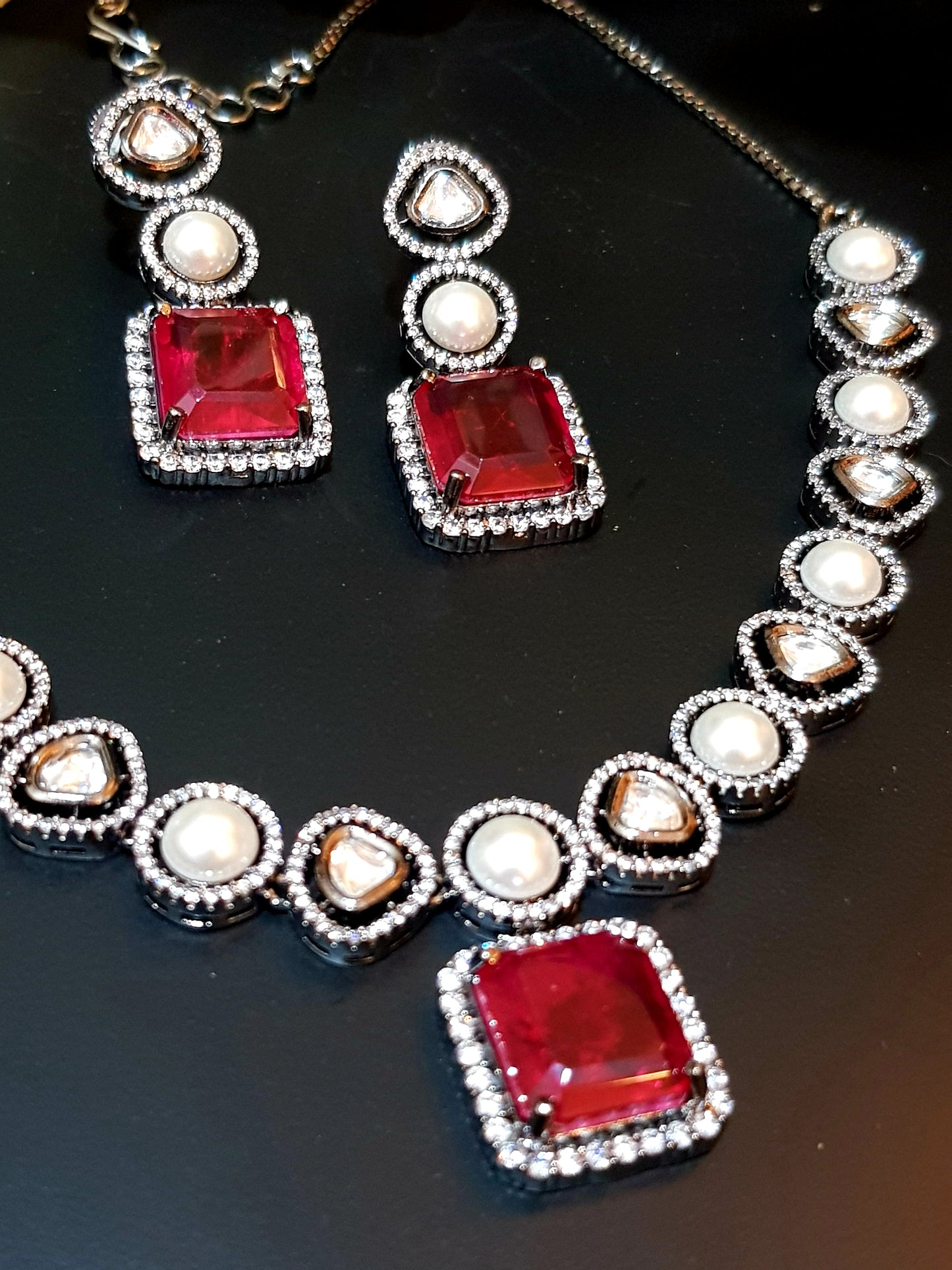 Antique silver finish set with square shaped ruby pendant on Kundan and pearl strand,matching earrings