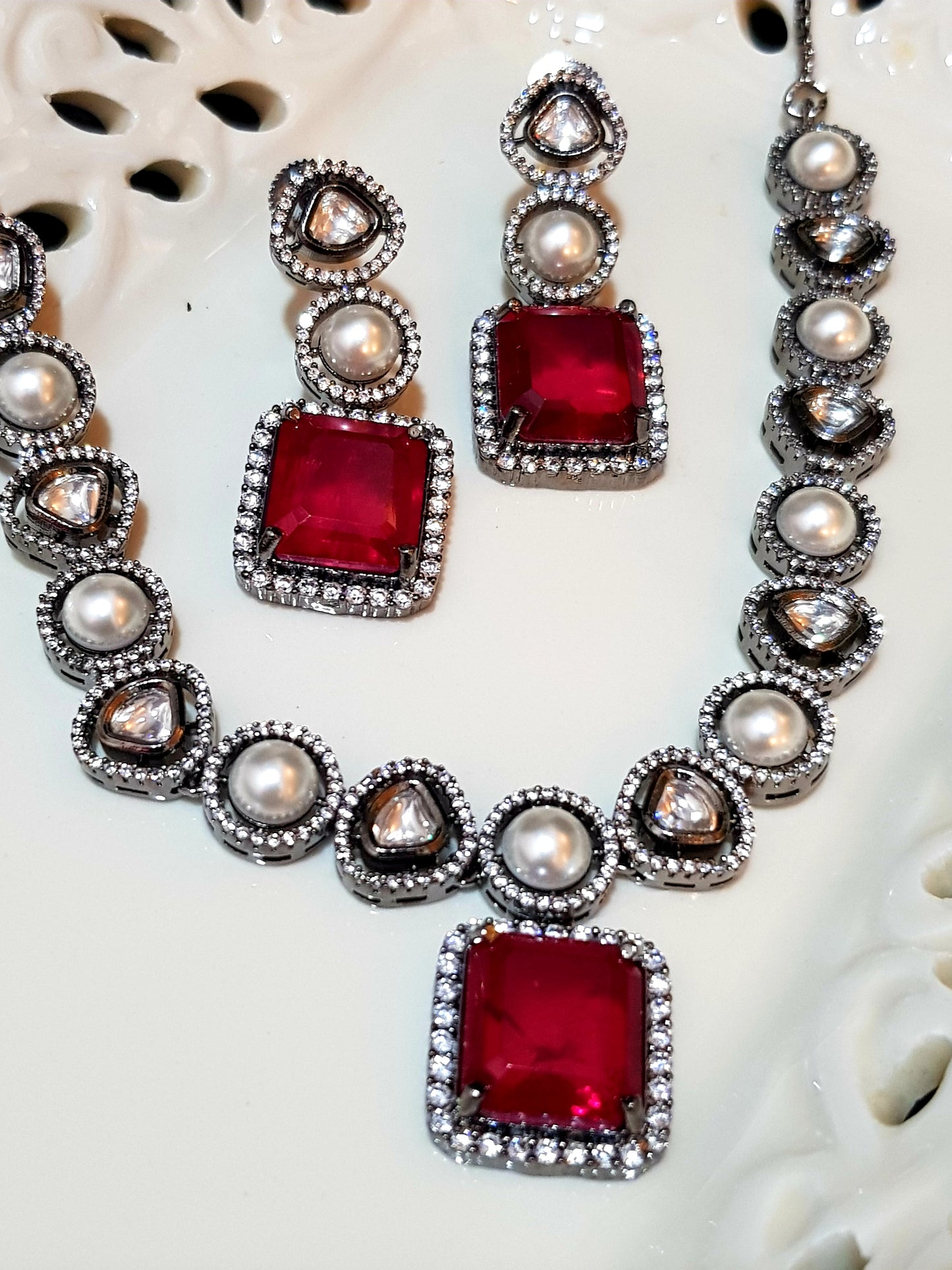 Antique silver finish set with square shaped ruby pendant on Kundan and pearl strand,matching earrings