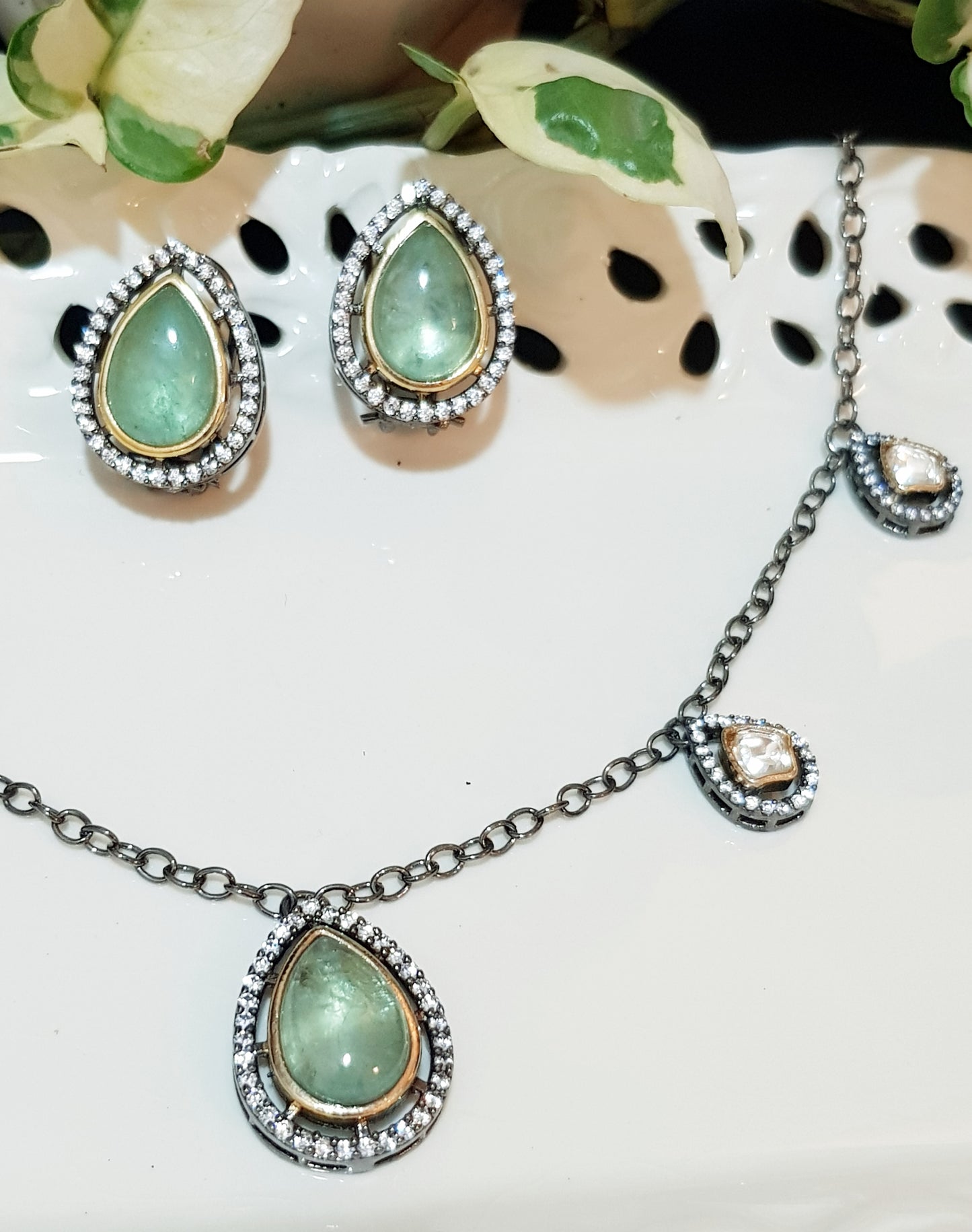 Antique finish set with pale green big pieces surrounded by CZ , matching studs (earrings)