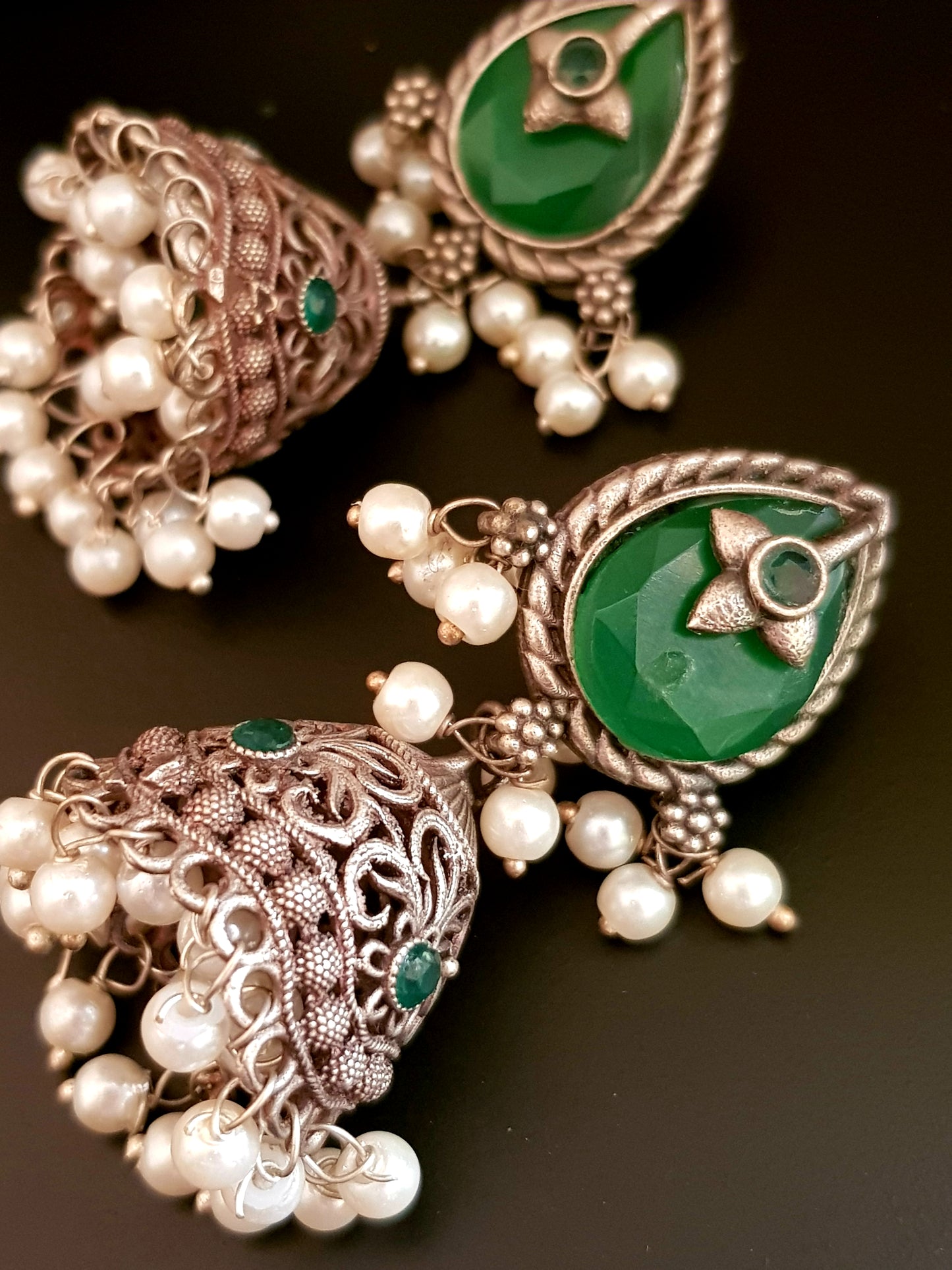 Silver finish jhumka (earrings), jaali designed dome under studs with green/white marble tearshaped stone